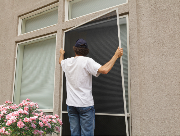 Window cleaner installing window screen after screen and track cleaning