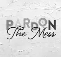 Text on a white brick wall that reads 'PARDON The Mess'