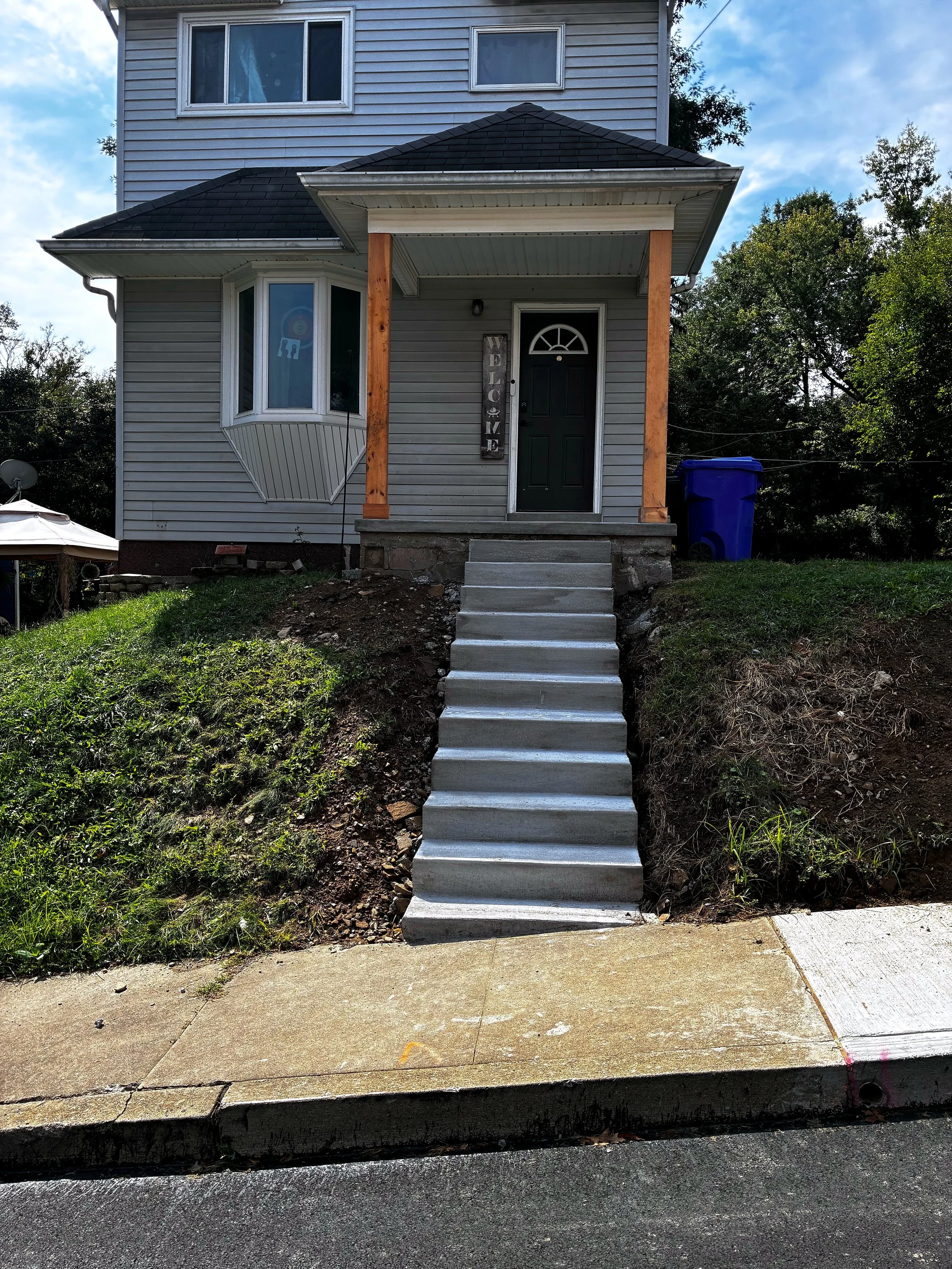 New concrete front steps leading up to a house in Butler, PA