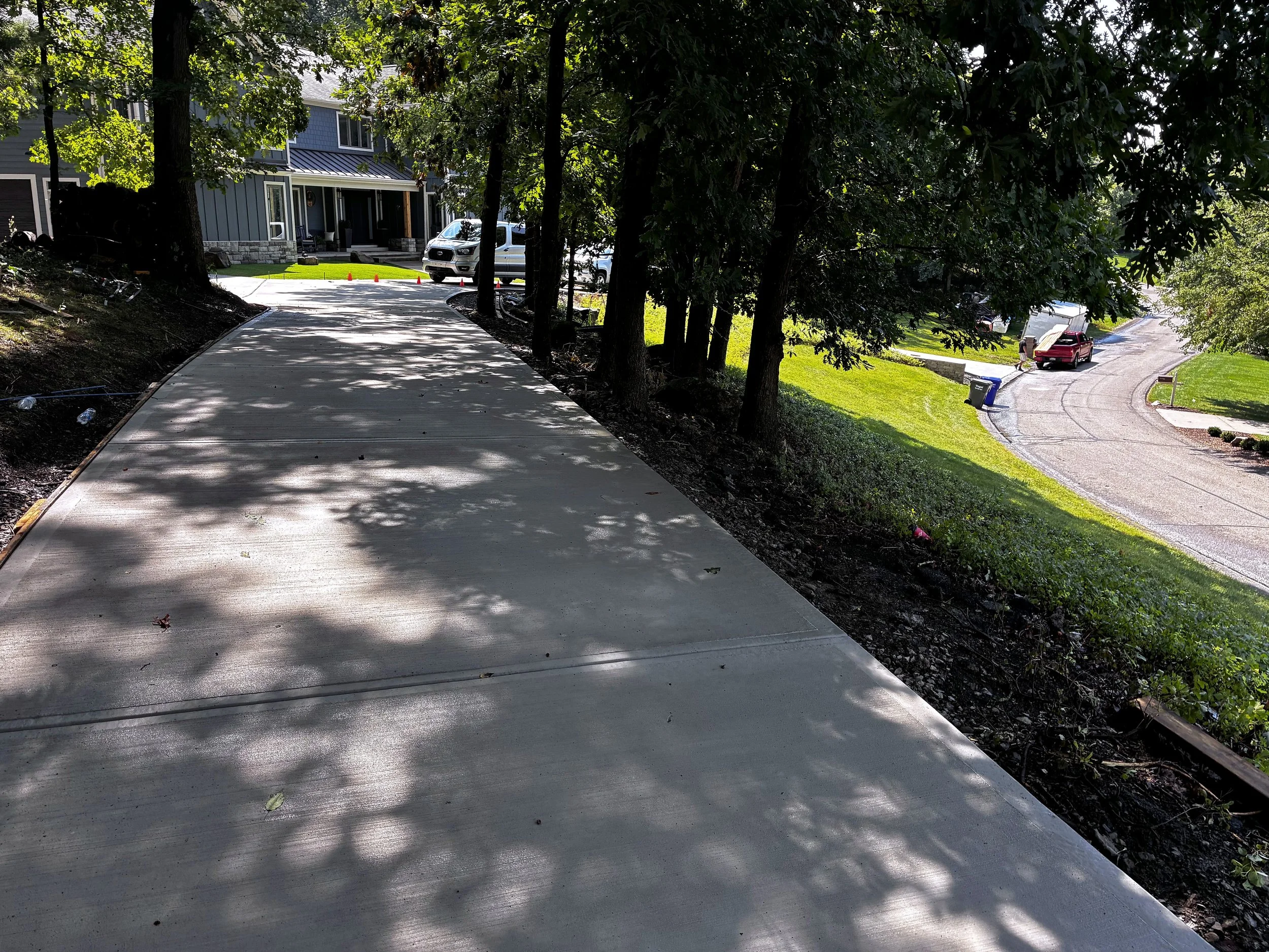 Finished concrete driveway curving uphill in Butler, PA