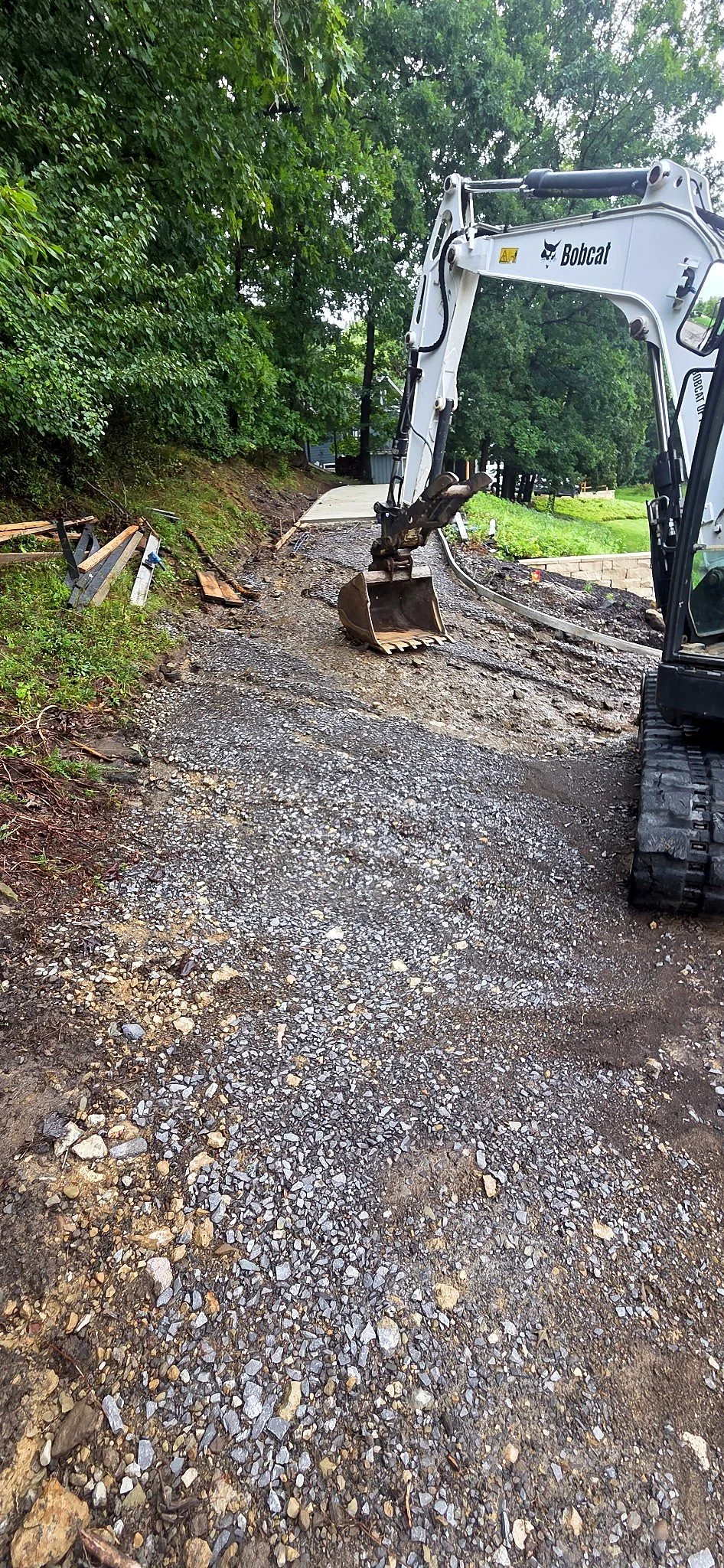Bobcat excavator grading a gravel path in Butler, PA