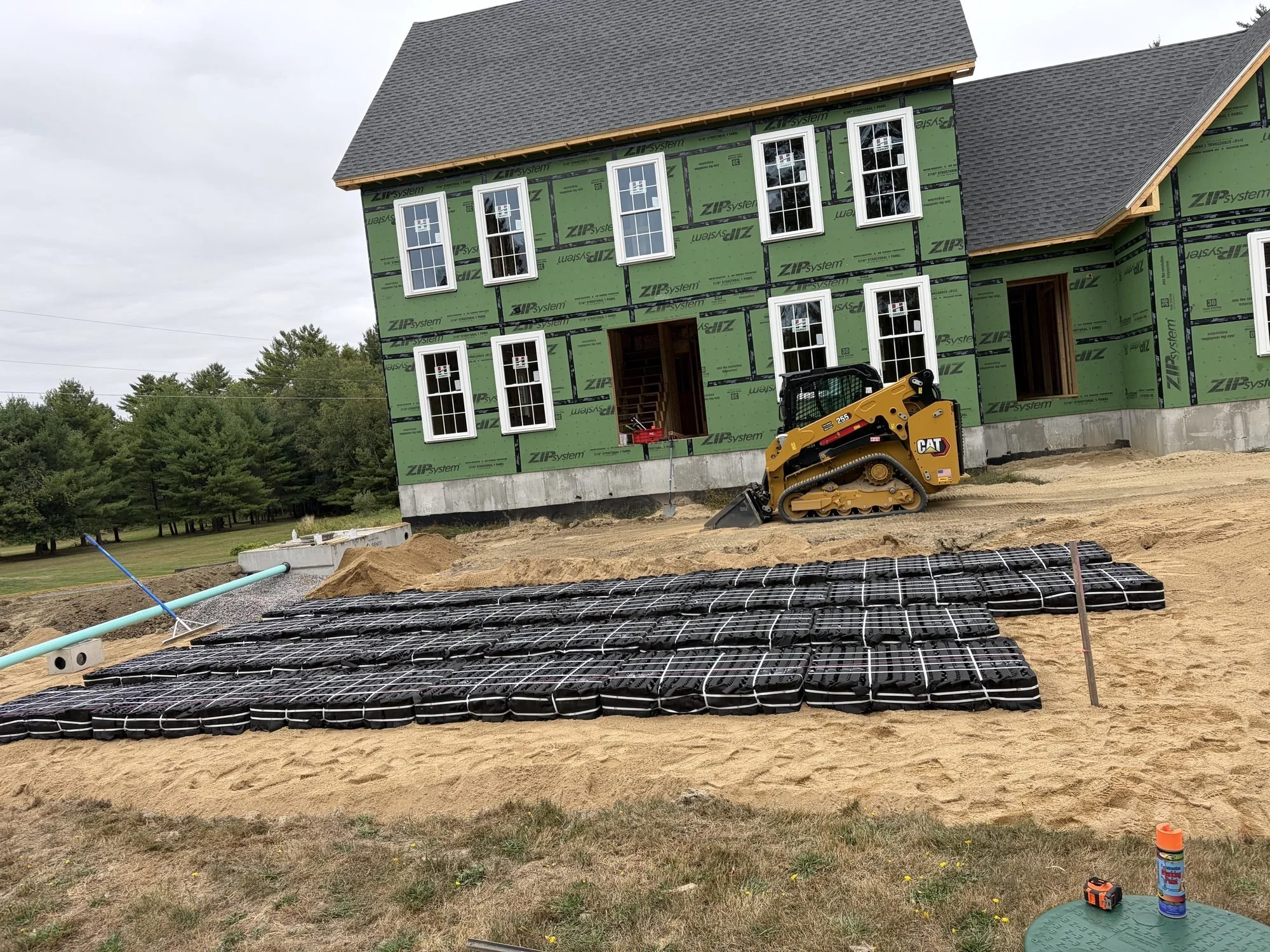 New septic drain field installation with leach bed materials staged at a York County, Maine job site