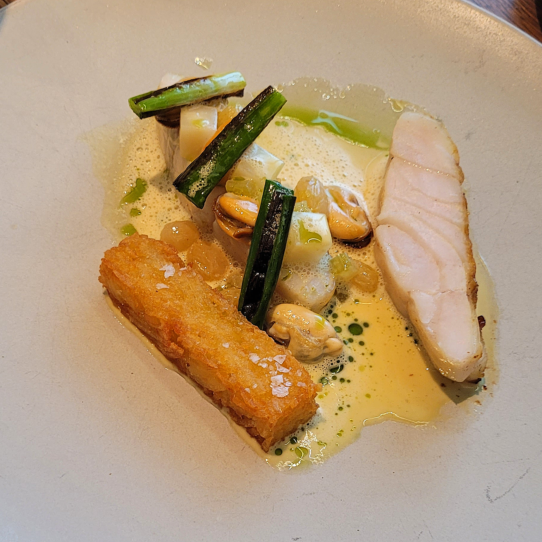 Roasted fillet of pollock with mussels and hash brown.