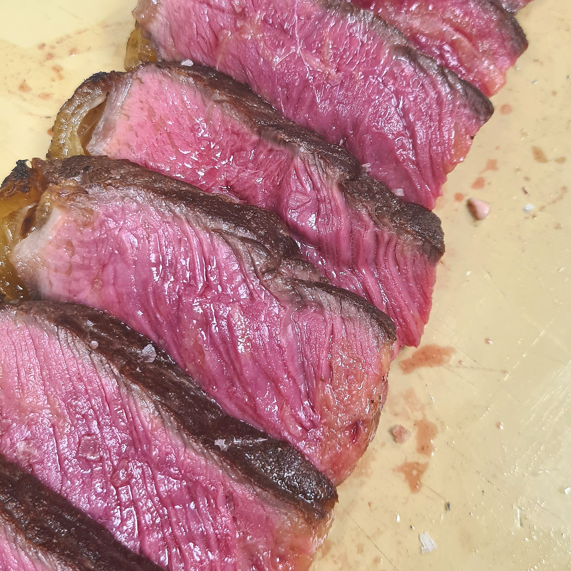 Cooked and sliced of a well-aged, perfectly cooked sirloin steak.