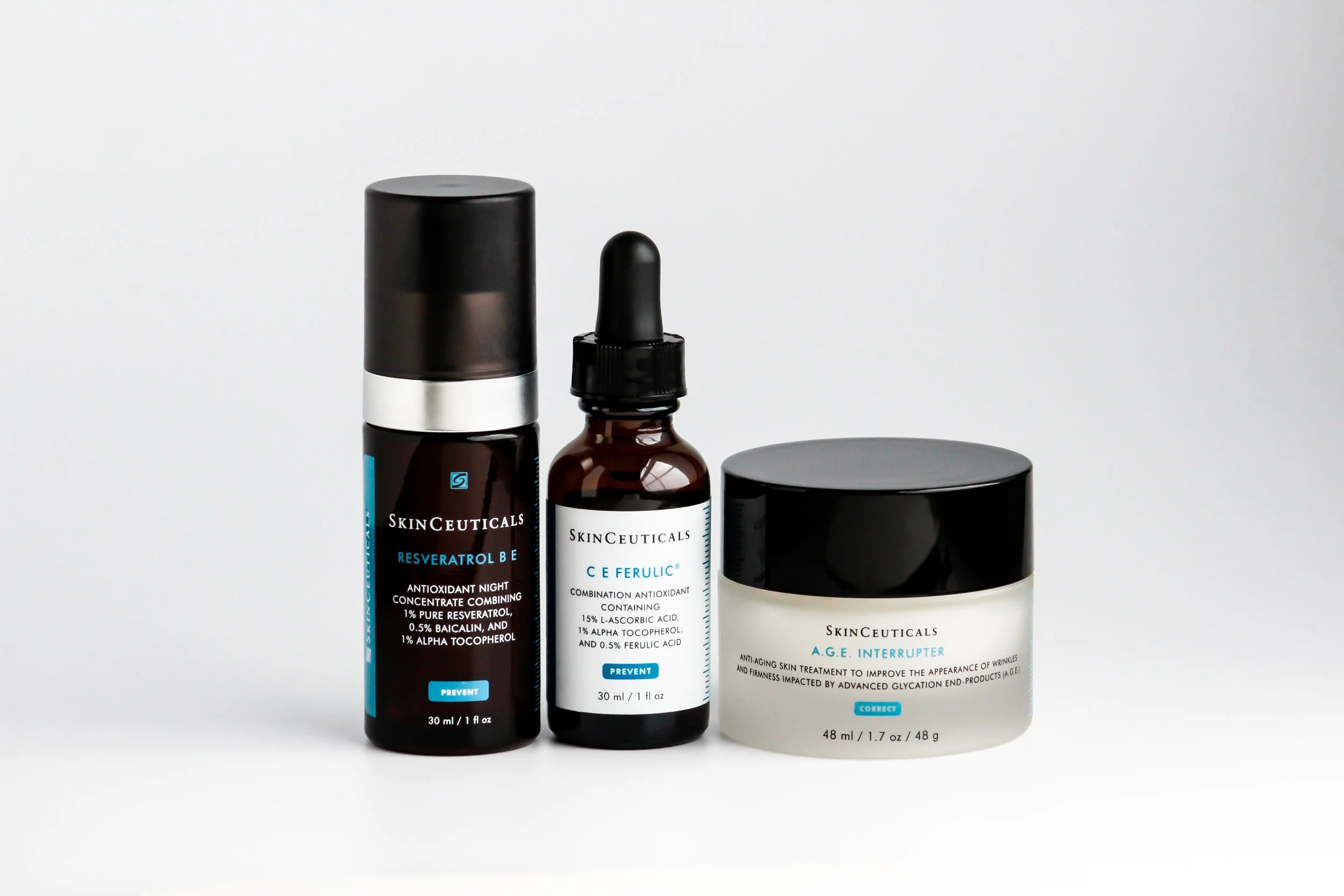 Three skincare products from SkinCeuticals, including bottles and a jar, placed against a plain white background.