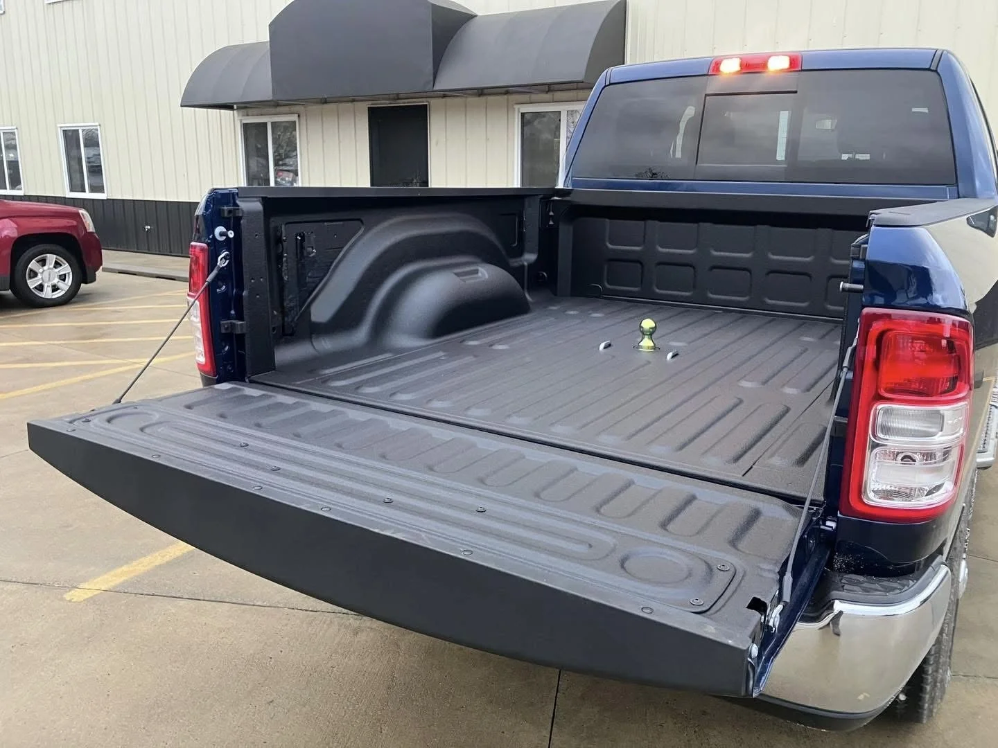 Finished spray-on bedliner in a red pickup truck with the tailgate down