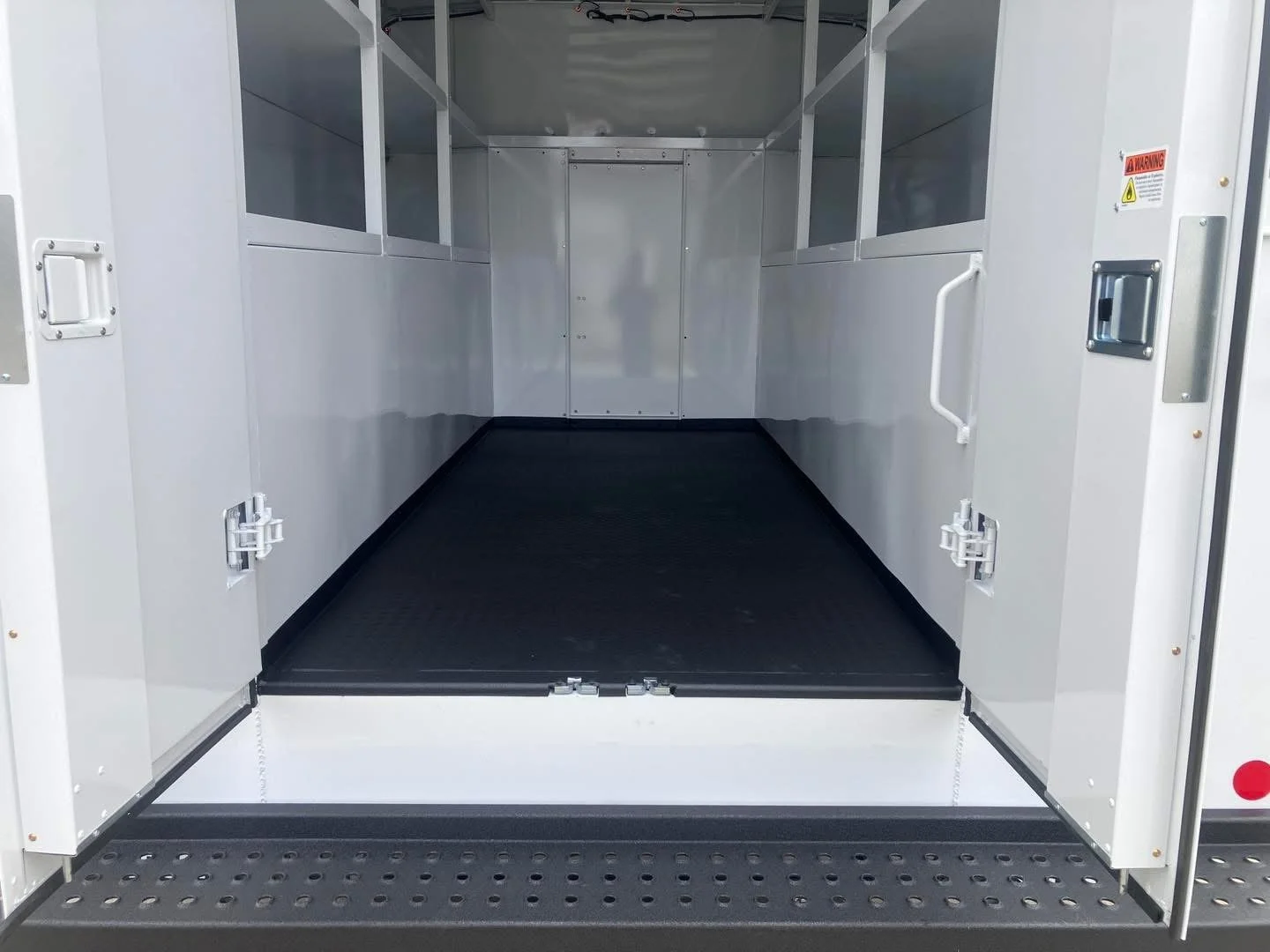 Spray-on liner applied to a white utility service truck body