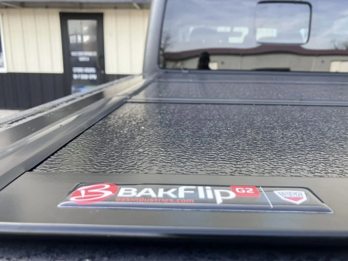 Hard folding tonneau cover on a pickup by Grenade Offroad