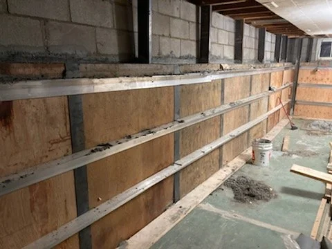 Construction site with wooden and metal framing on a concrete wall