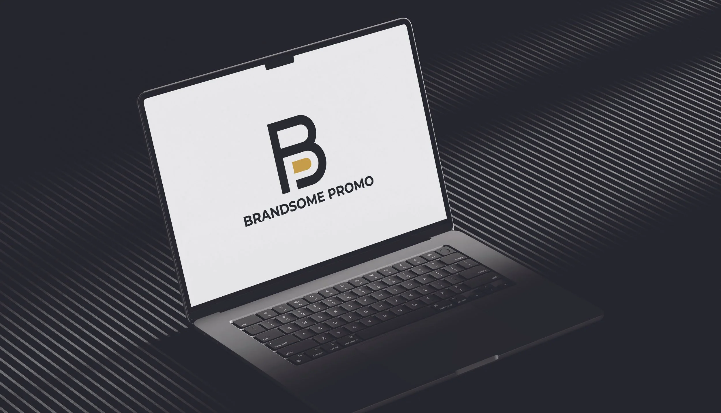Open laptop displaying a logo with the letters B P and the words 'BRANDSME PROMO' on the screen, placed on a dark textured surface.