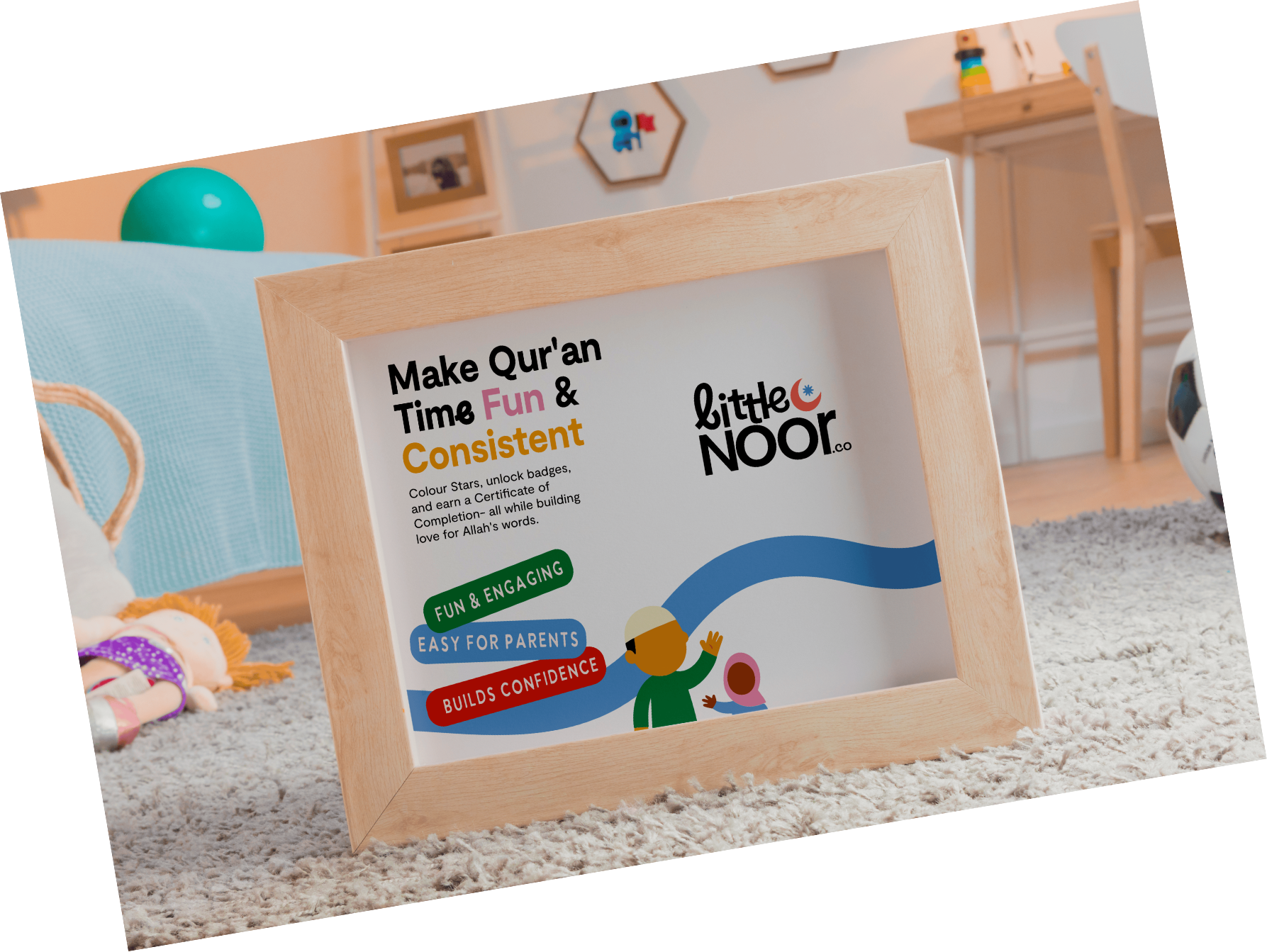 A wooden-framed sign on a fluffy carpet in a room with colorful wall decorations and a wooden shelf. The sign advertises a Qur'an learning program for children, highlighting themes like fun, engagement, and building confidence.