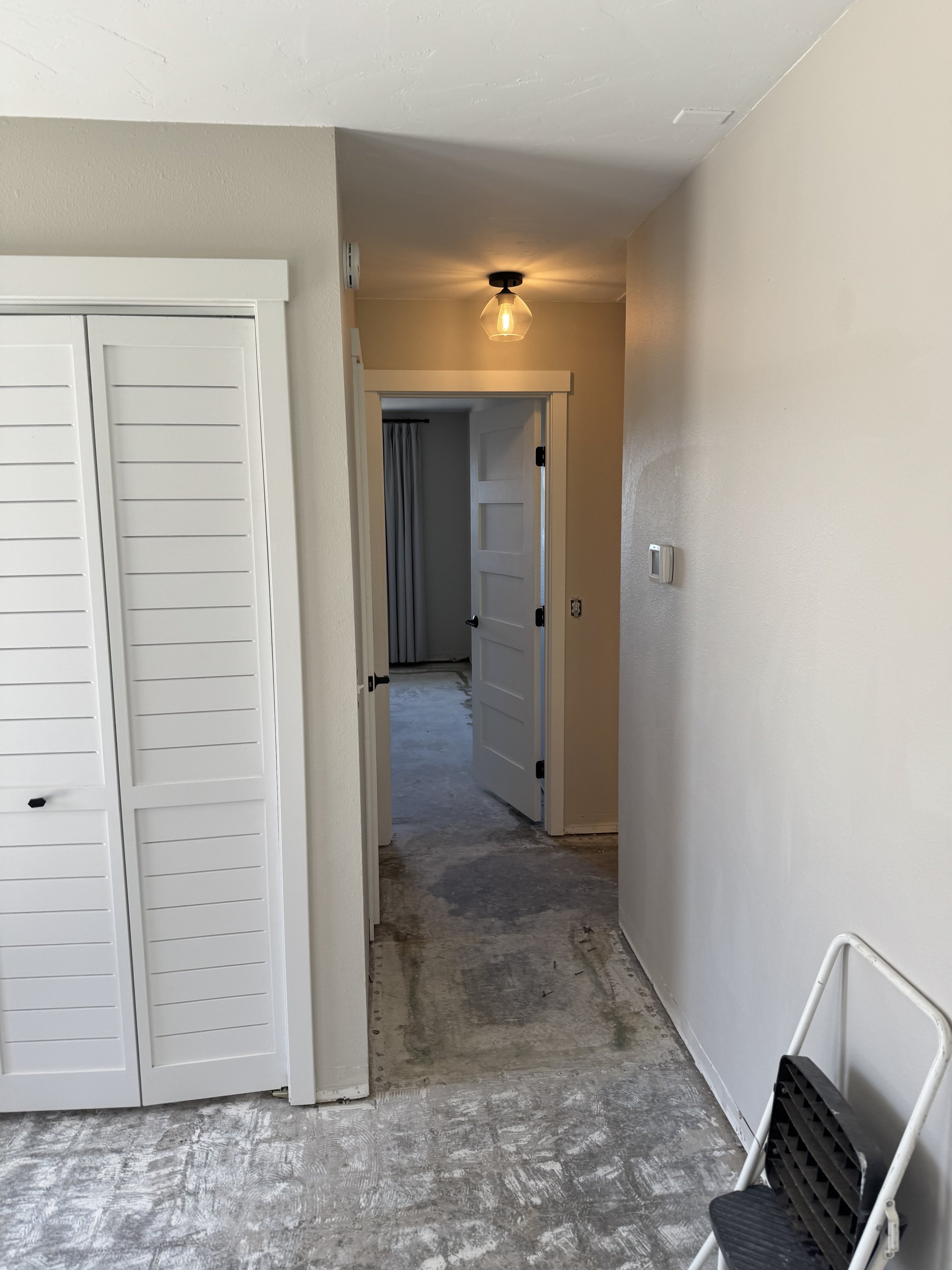 Hallway and door to guest bedroom. That is a closet with bi-fold doors in the left side of pic.