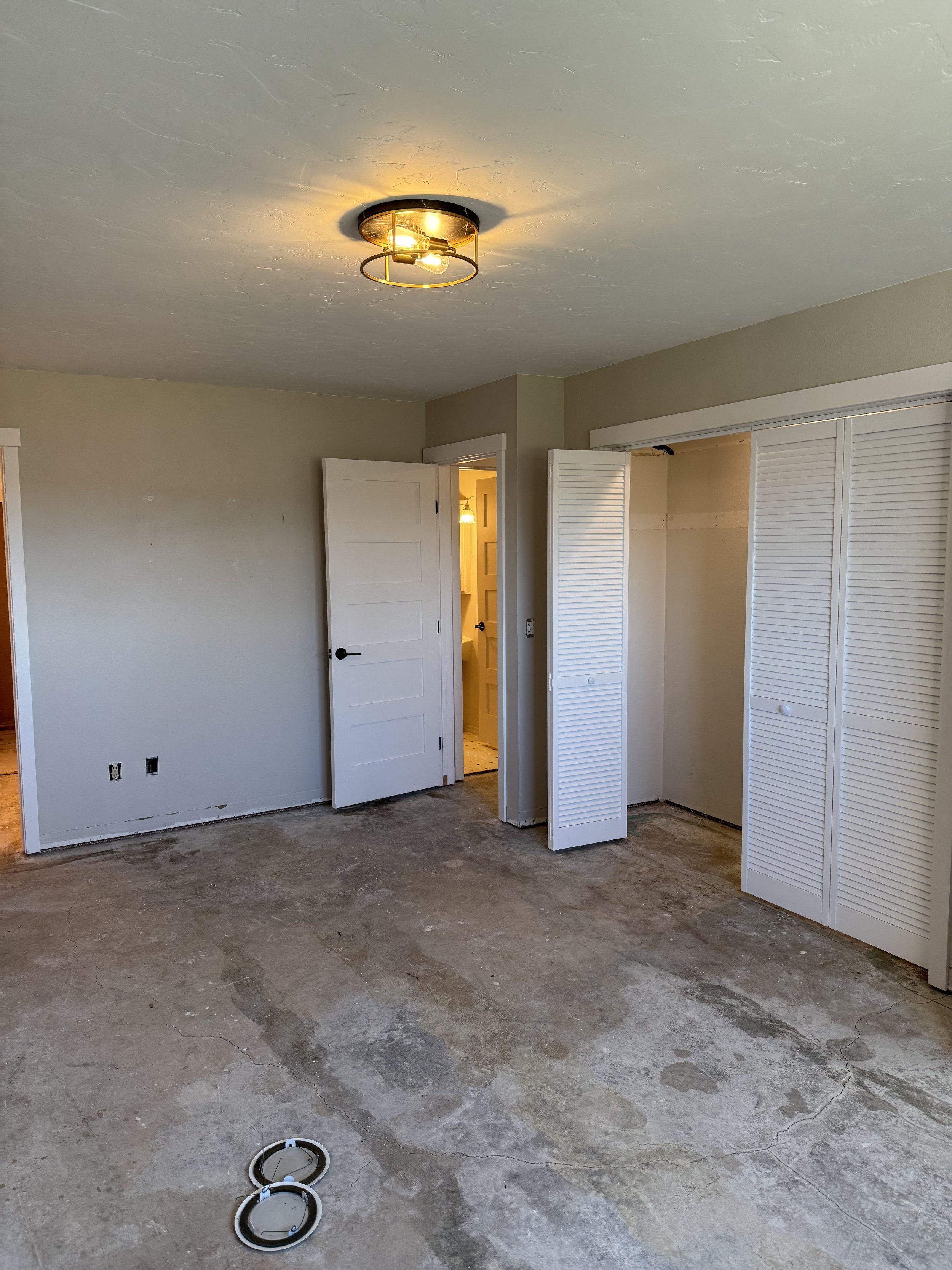 Master bed looking at entry and closet.