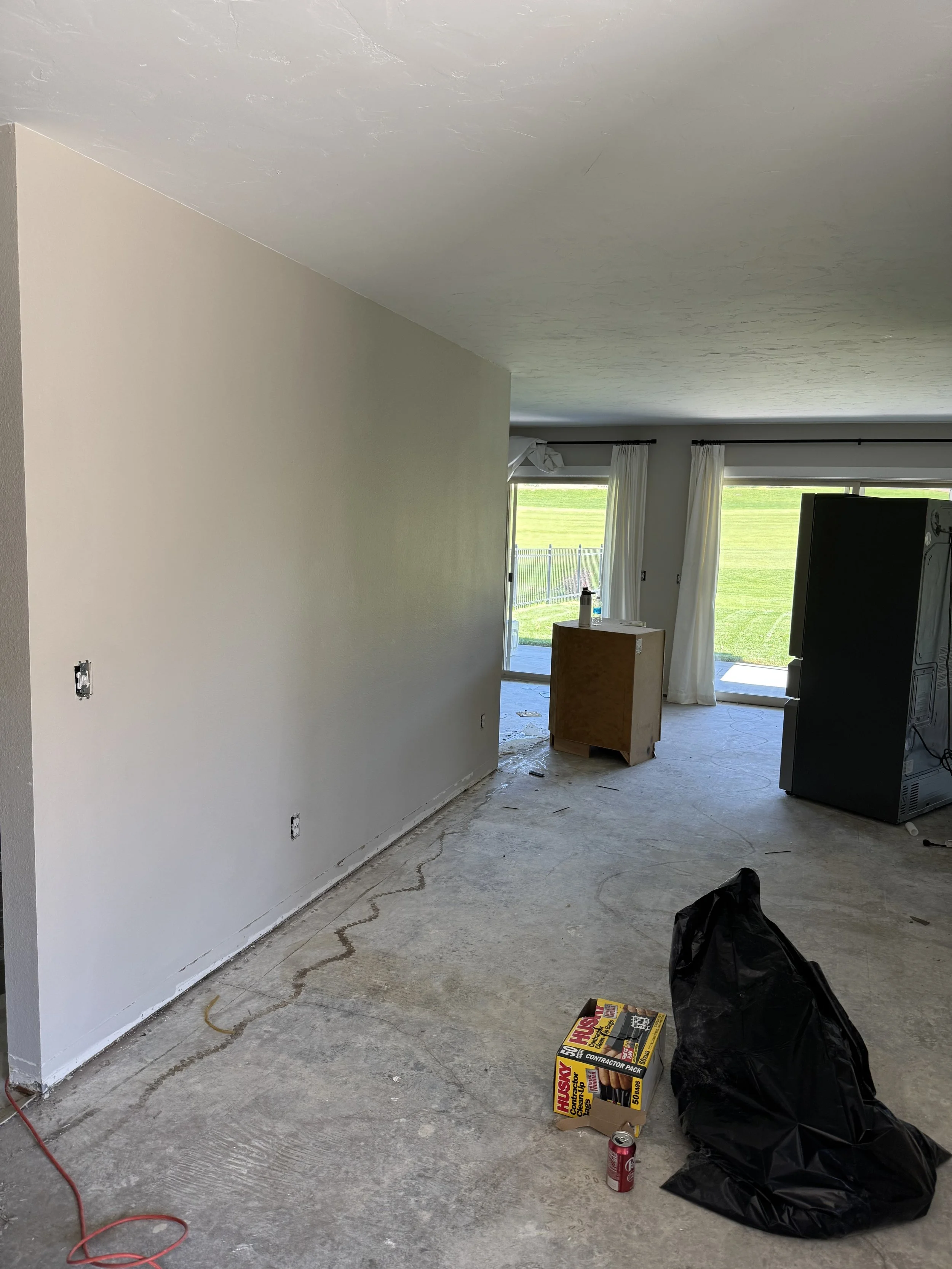 Picture taken from front entry looking at living kitchen divider wall.