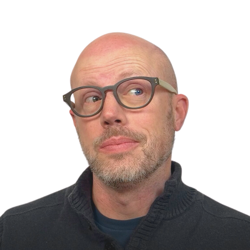 A middle-aged man with glasses and a beard, looking to the side with a thoughtful expression, against a plain white background.