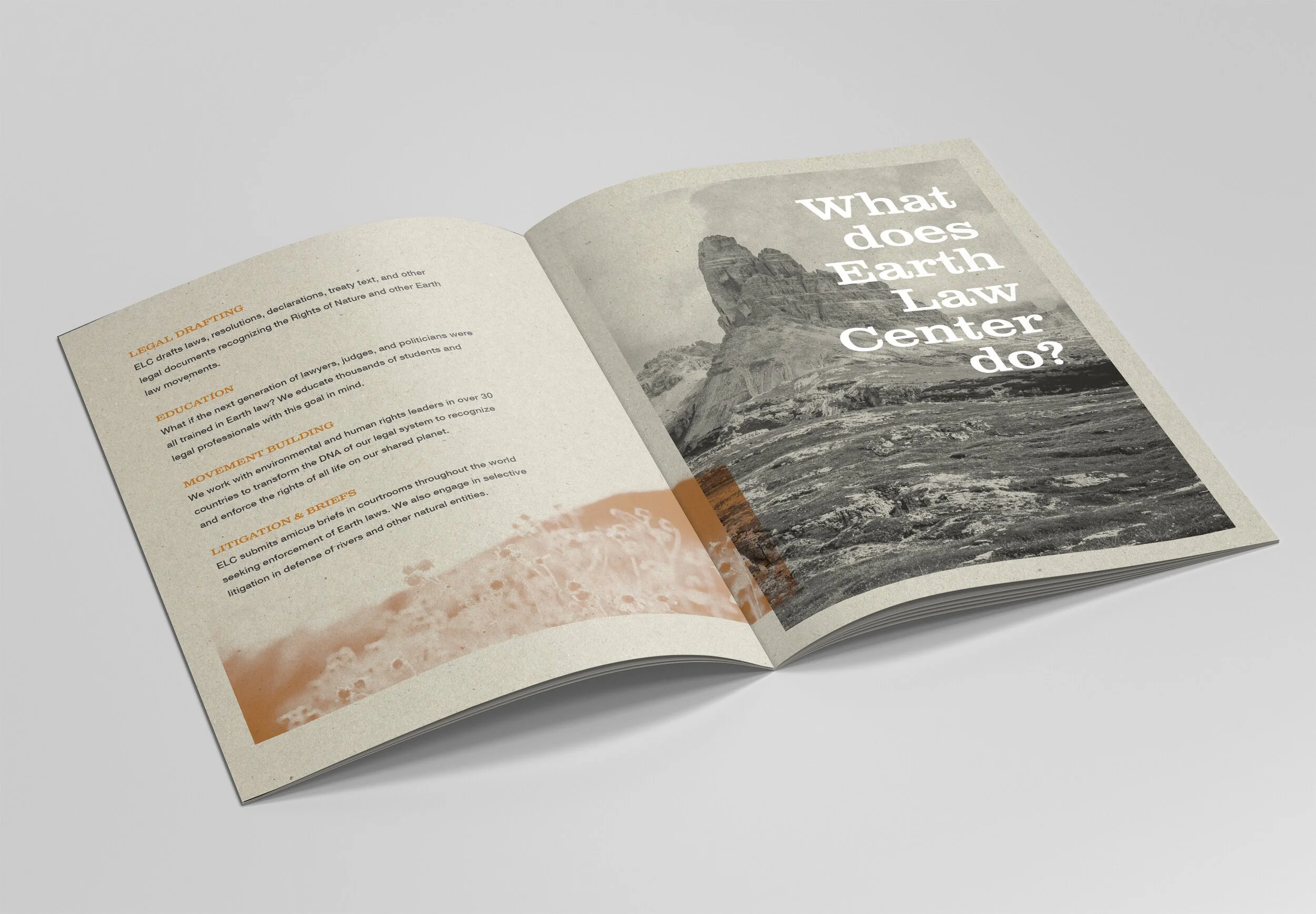 Open pamphlet with text and a black and white mountain photograph on a plain background.