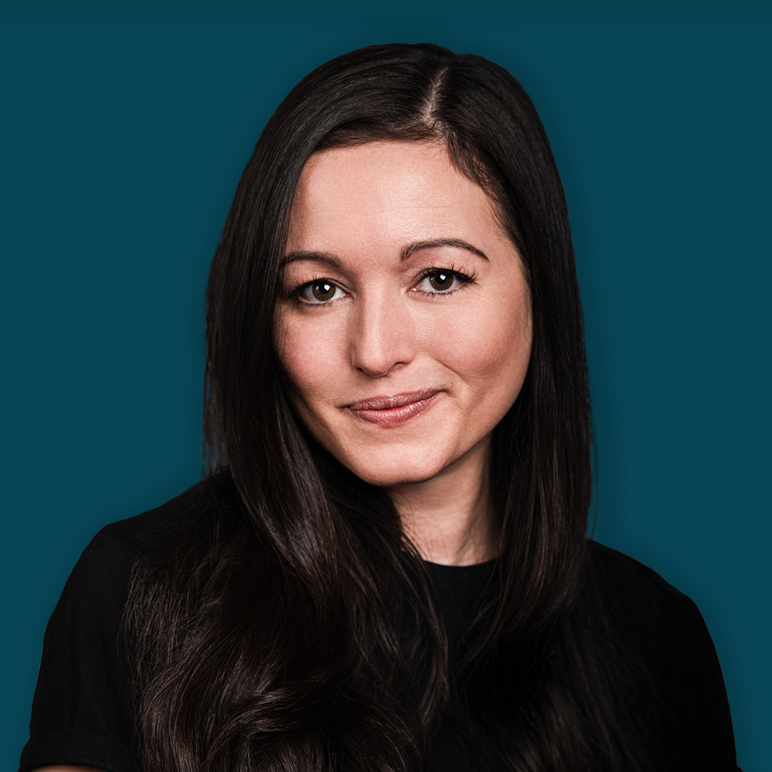 A woman with long dark hair, winking and smiling, wearing a black top against a solid teal background.