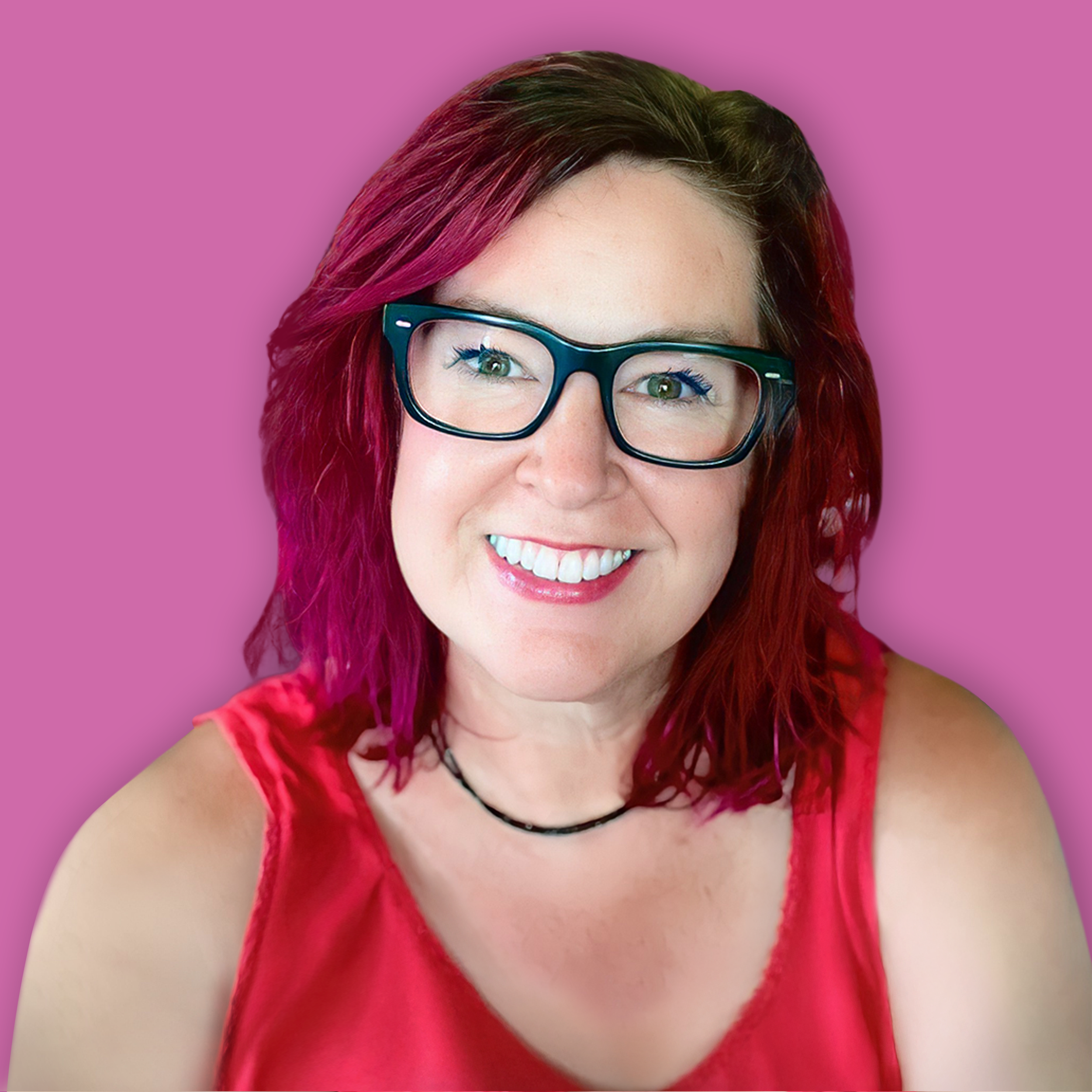 A smiling woman with red and dark brown hair, wearing glasses and a red top, against a pink background.
