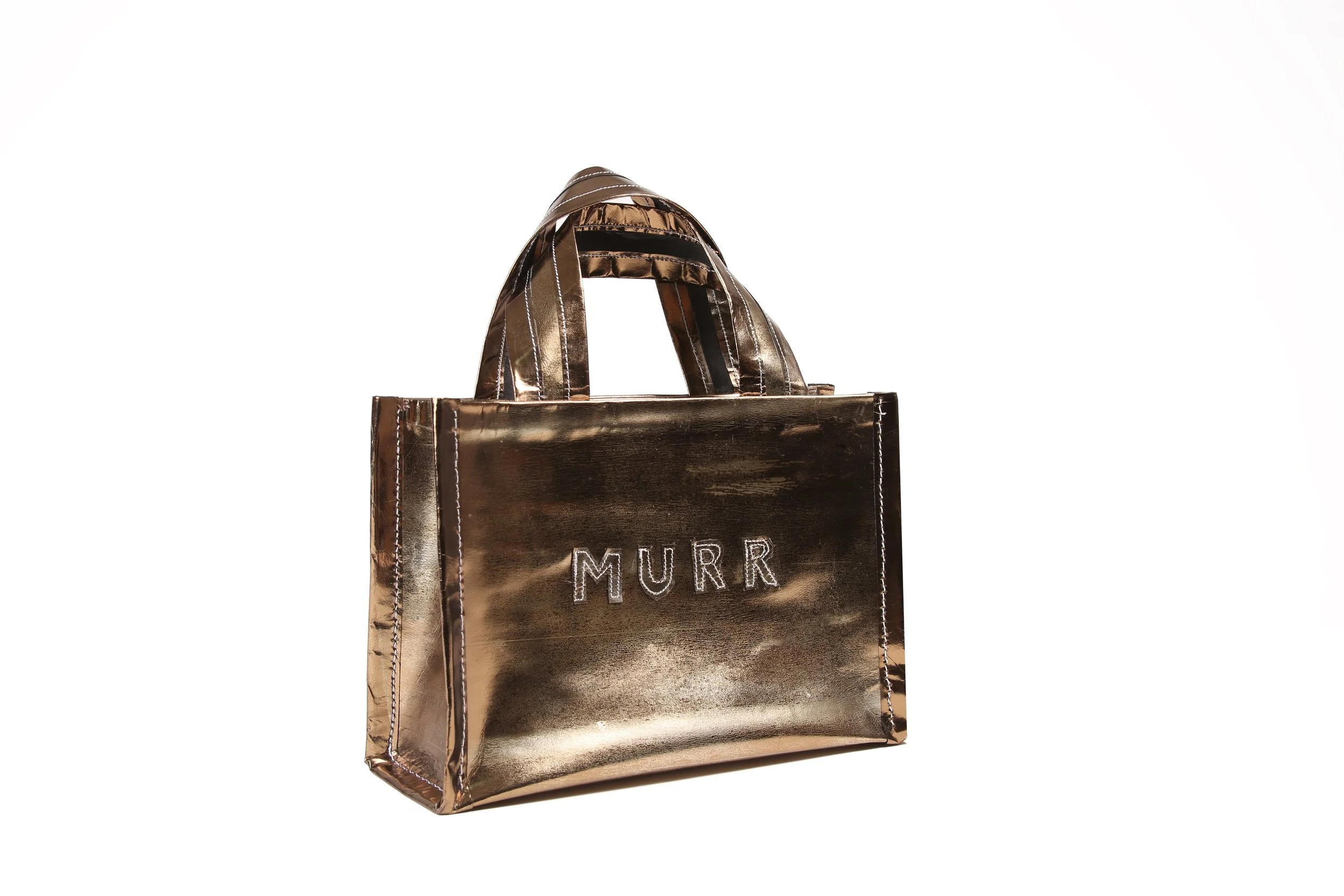 A metallic bag with the name "MURR" embroidered on it.