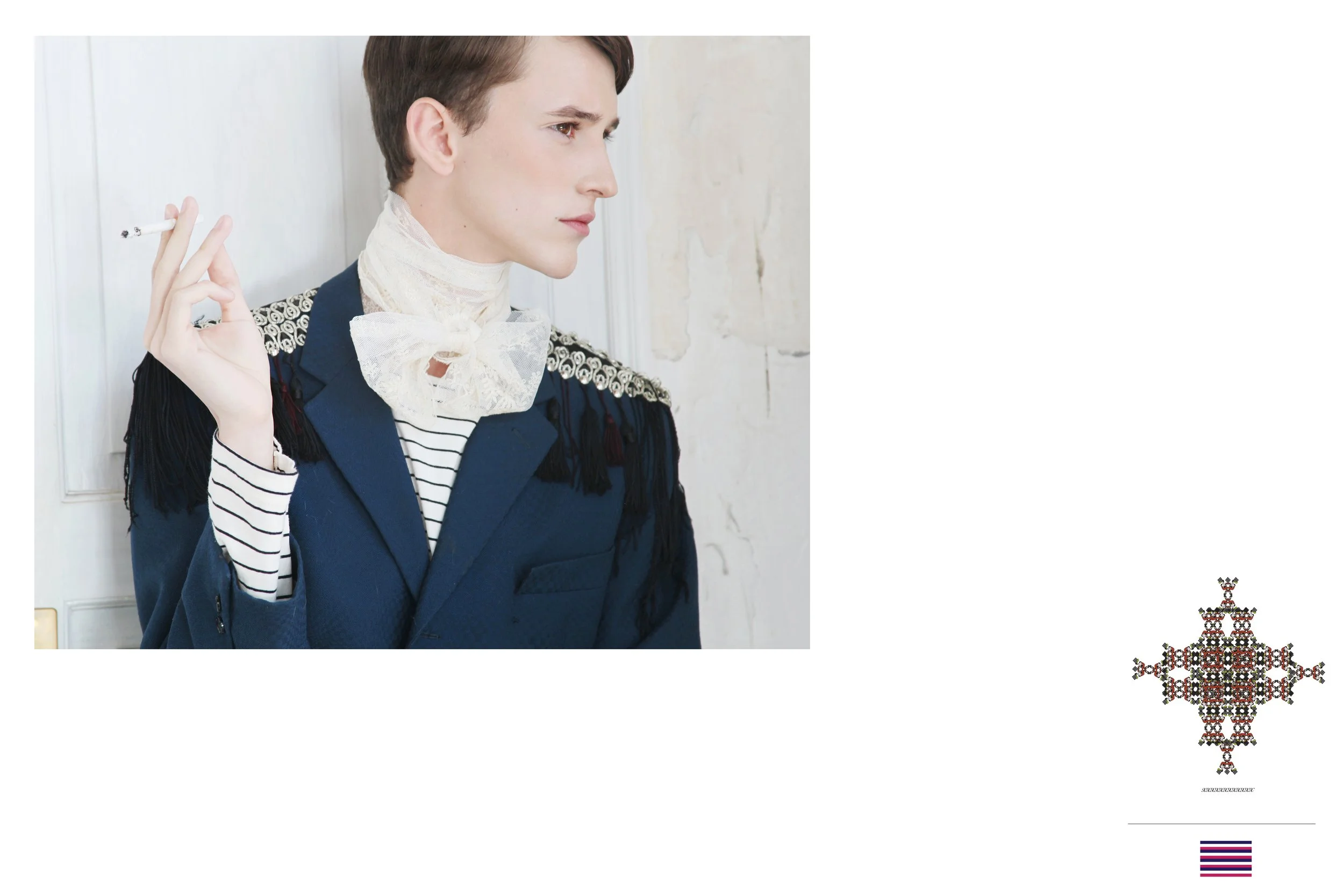 A young woman with short brown hair and fair skin, wearing a blue blazer with decorative shoulder embellishments and a striped shirt, holds a cigarette in her right hand and looks to the side.