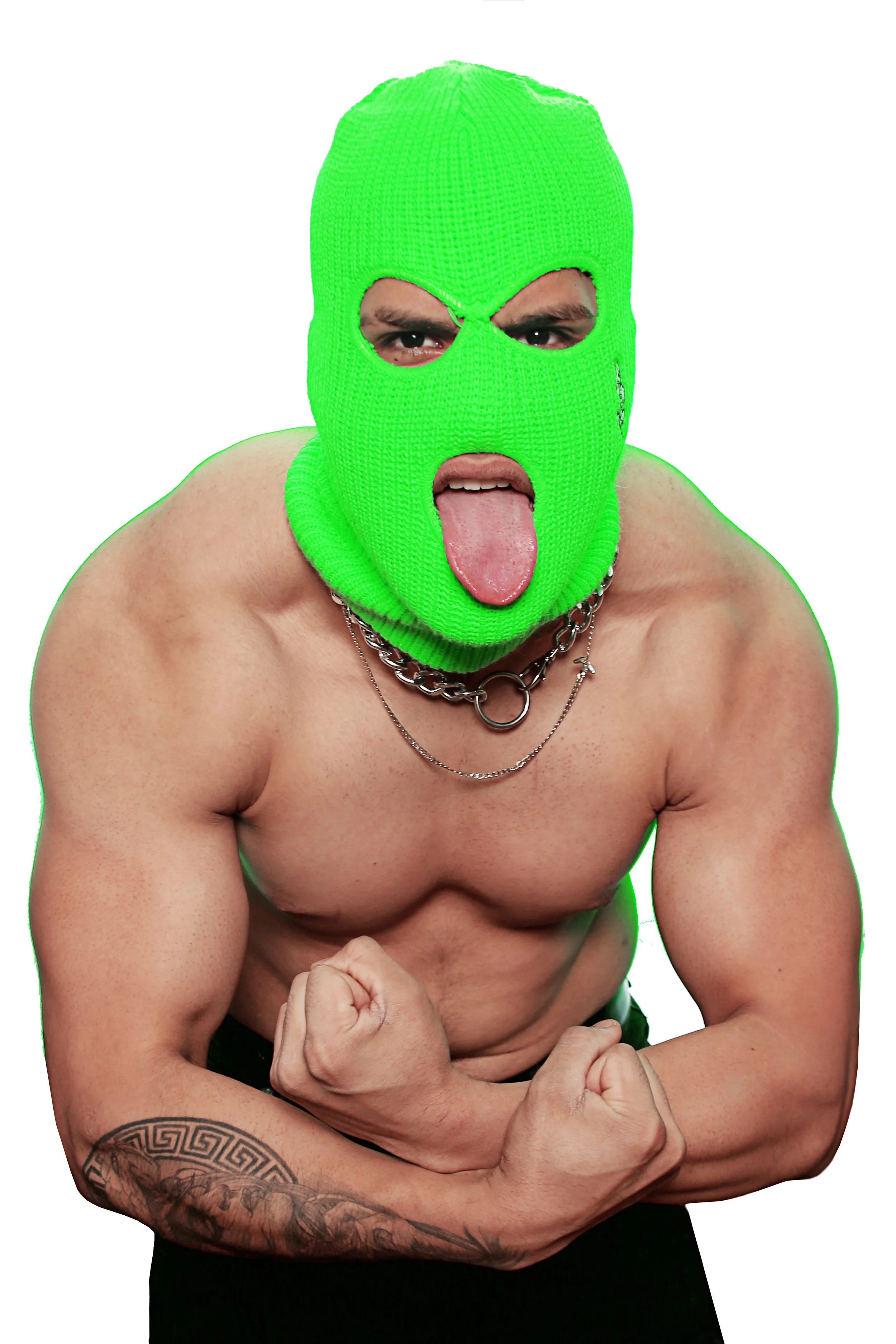 A person with a green ski mask covering their face, sticking out their tongue, shirtless with muscular arms, tattoos on the left arm, wearing multiple silver chains, flexing their right arm.