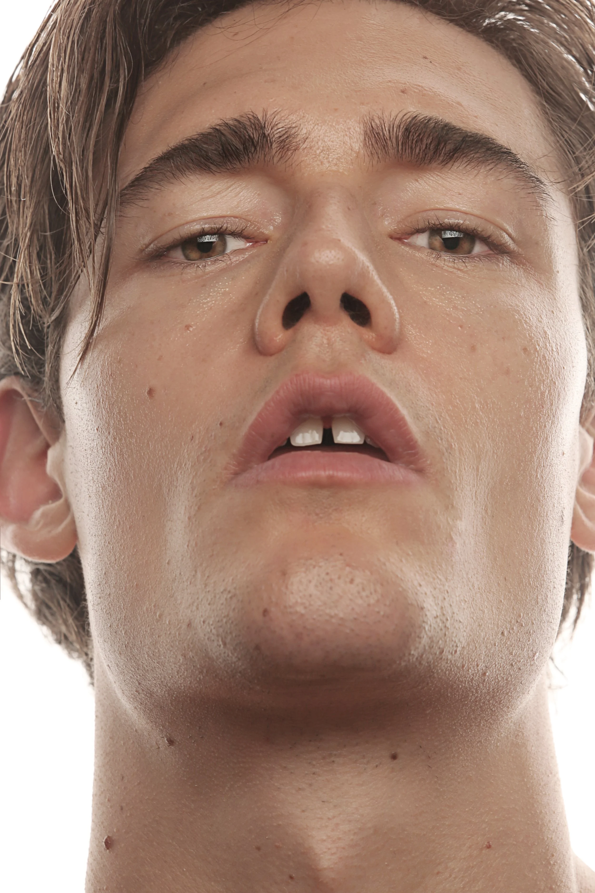 Close-up of a person's face with a neutral expression, showing their eyes, nose, lips, and skin texture.