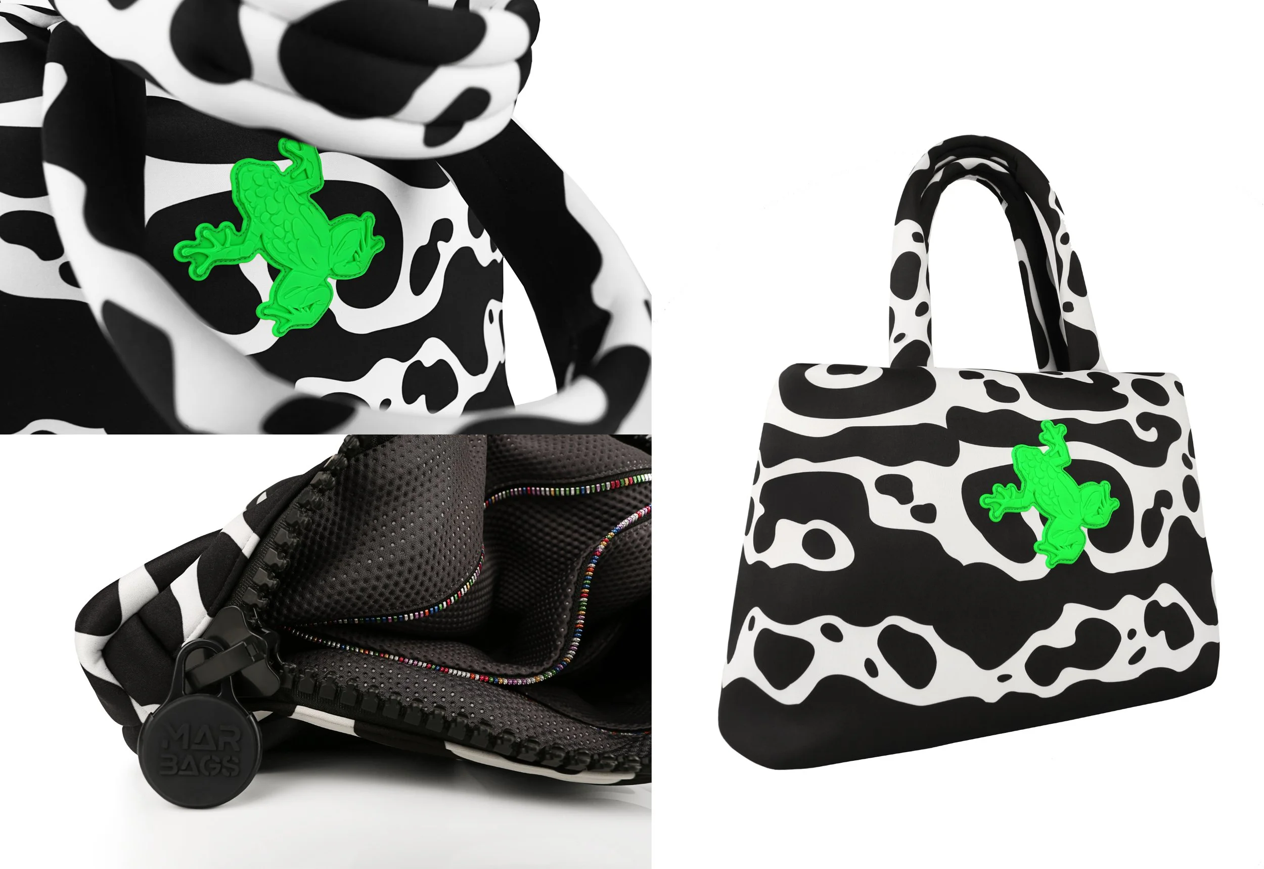 Close-up of a black and white cow print bag with a neon green frog logo on the front and a black zipper with rainbow stitching, and another cow print bag in the background.