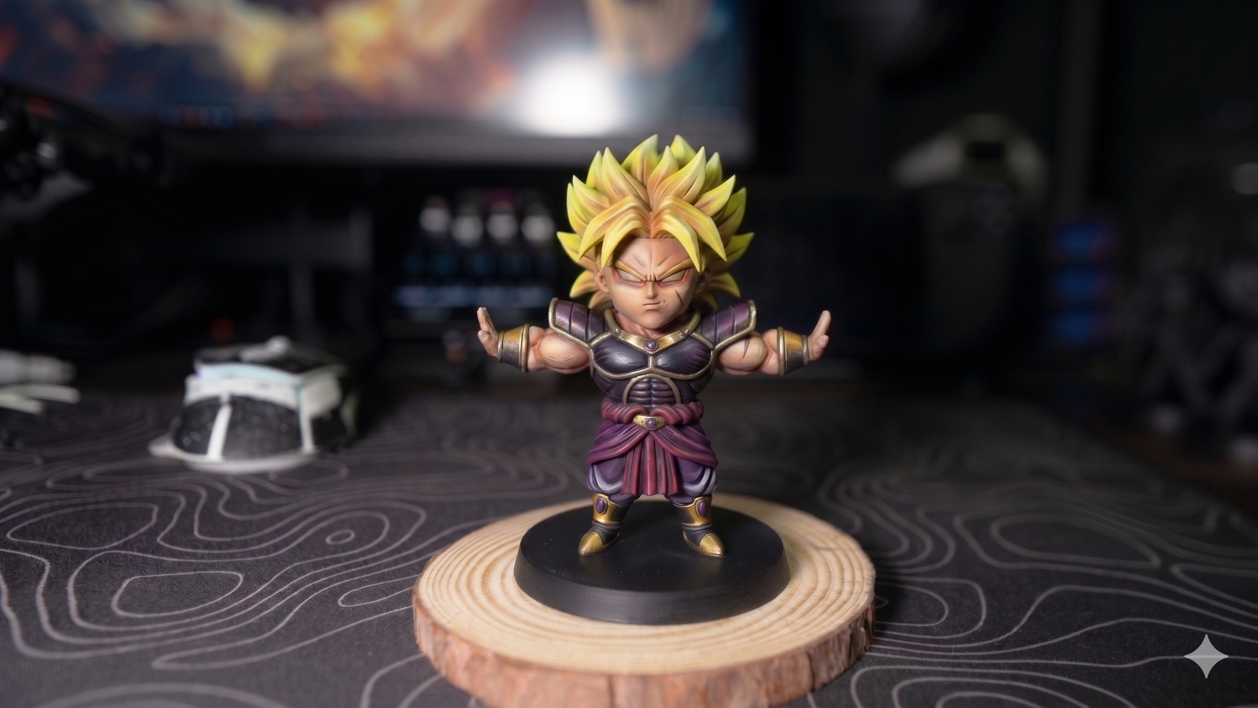 A chibi-style figurine of a character from Dragon Ball Z with golden hair, purple and black armor, and a confident stance, placed on a wooden coaster.