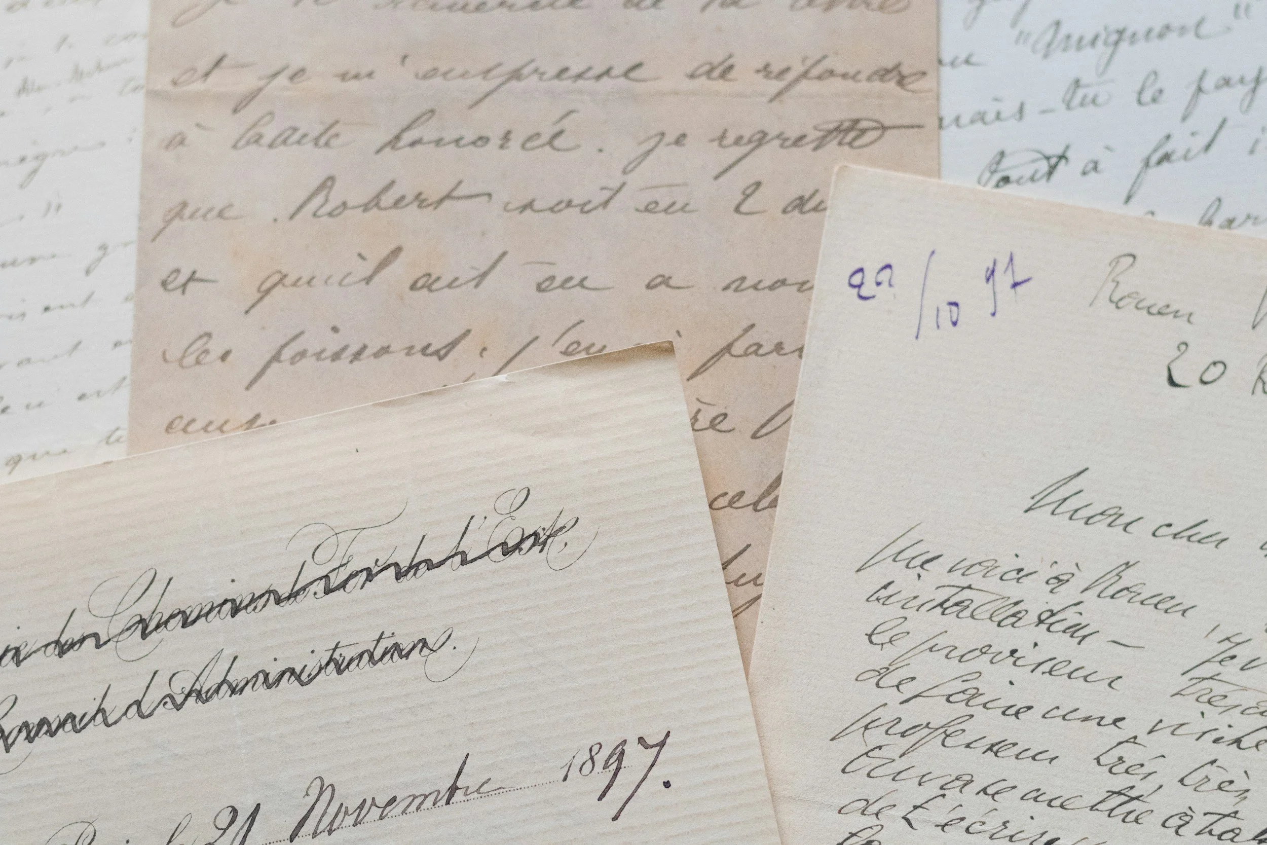 Close-up of handwritten old letters or documents, with cursive writing in ink and some handwritten notes in pencil.