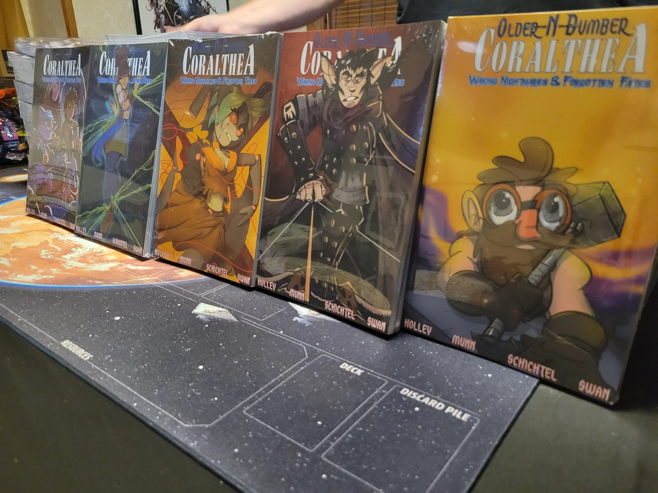 Comic book covers displayed on a table, featuring characters with fantasy and adventure themes.
