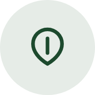 Green map pin icon with an exclamation mark inside