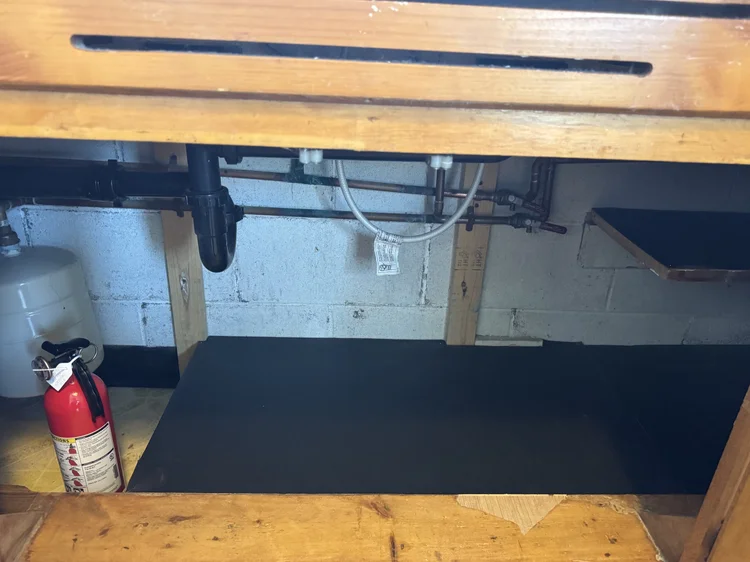After: under-sink cabinet with a new base and liner