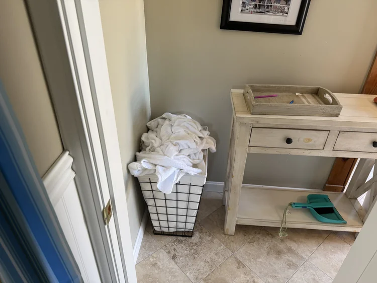 Before: used linens and laundry piled by a dresser