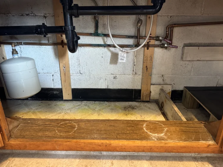 Before: under-sink cabinet with a bare, worn base