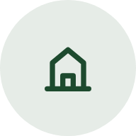 Green outline of a house with a door inside a light gray circle
