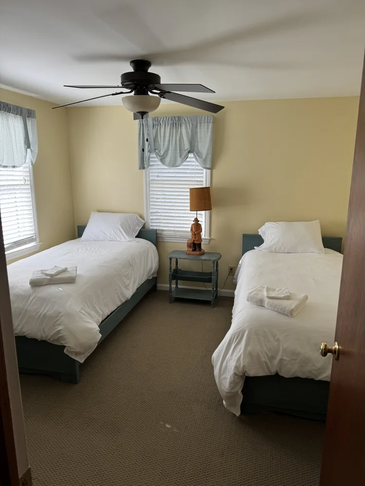 After: twin bedroom with fresh made beds and towels