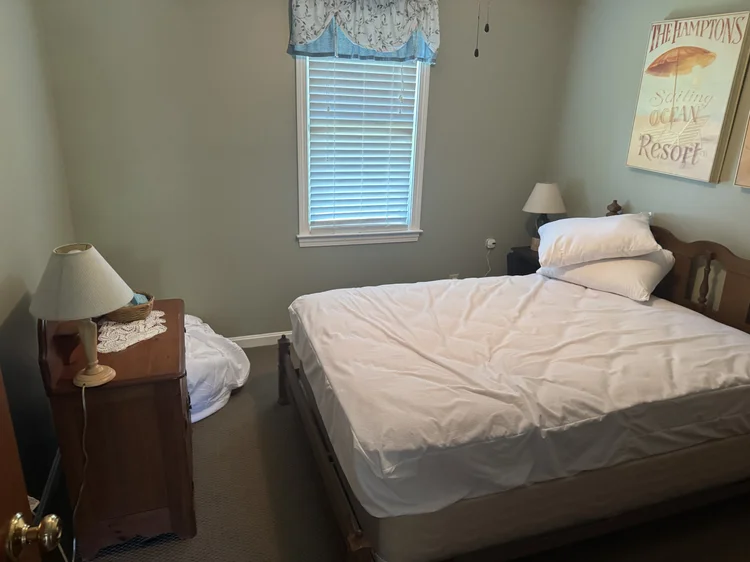 Before: guest room with used linens on the floor
