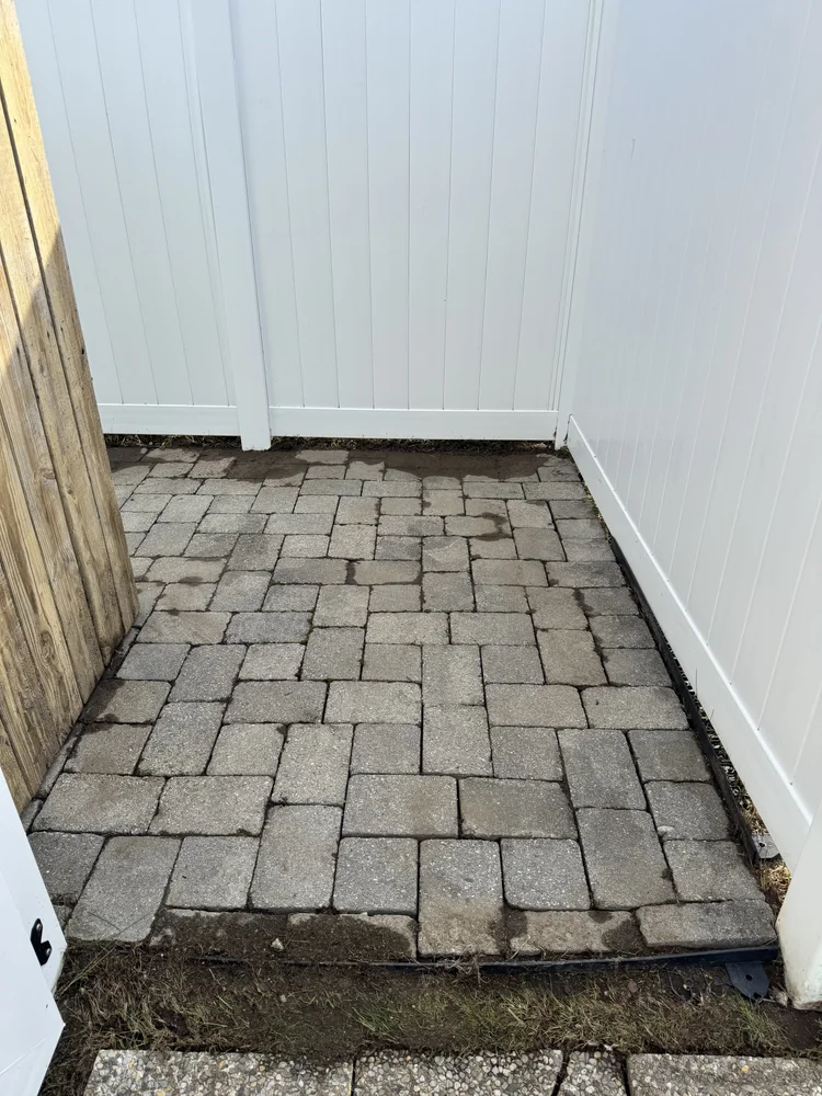 After: patio corner cleared with clean pavers