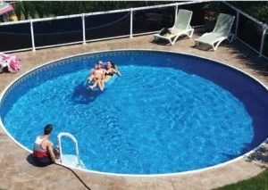 People relaxing in a swimming pool with lounge chairs nearby
