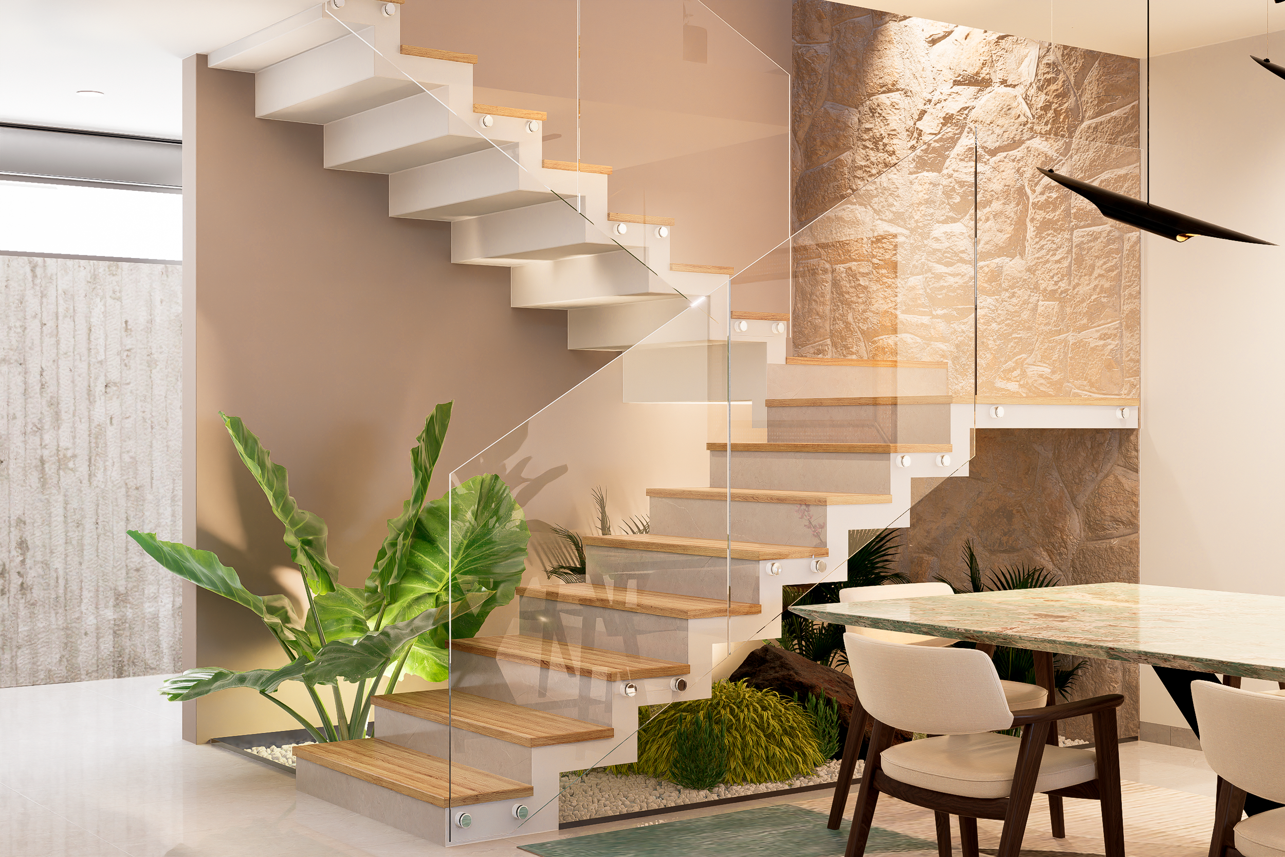 La escalera en el vestíbulo no solo es una pieza de diseño que aporta ligereza visual, sino que enmarca un jardín interior cobijado por un muro de piedra texturizada. Integrar la naturaleza viva dentro del hogar es un principio fundamental para mejor