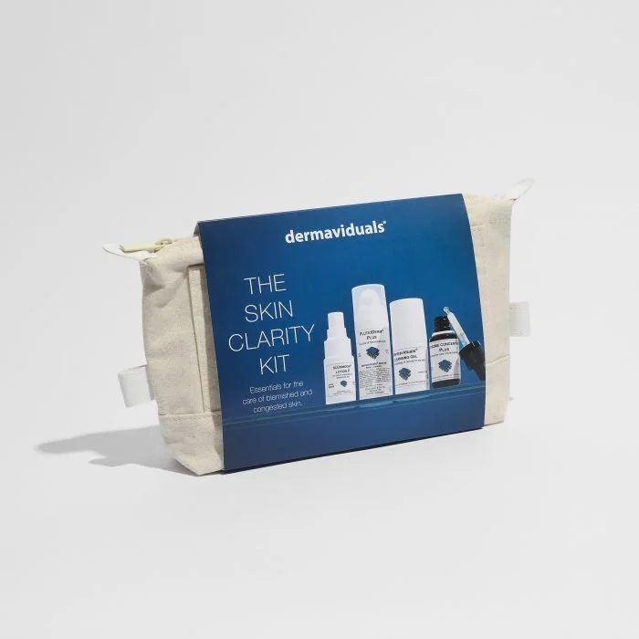 A skin care kit labeled 'dermaviduals The Skin Clarity Kit' in a beige fabric bag with a blue packaging insert showing four skincare bottles, set against a plain white background.