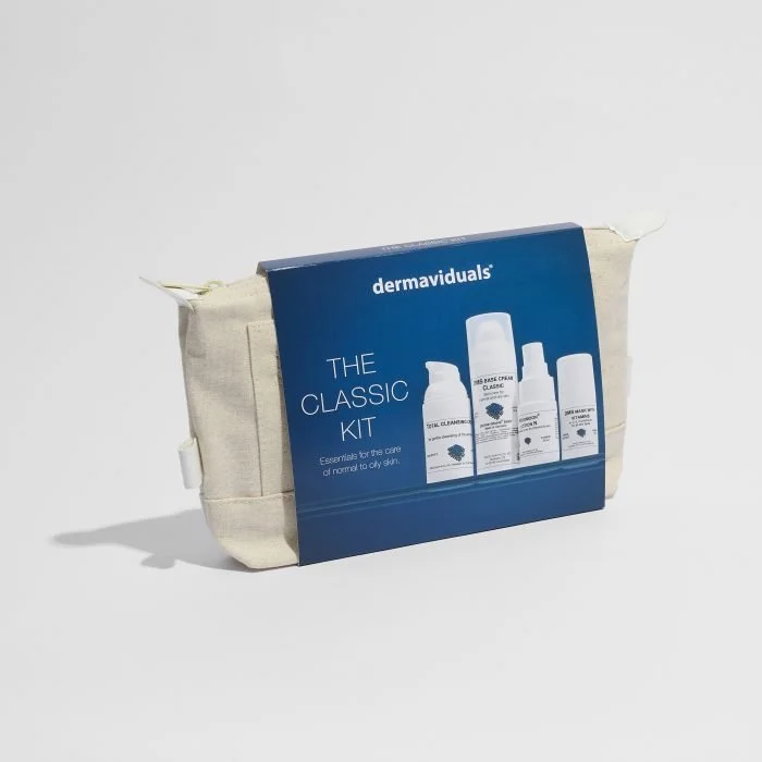 Dermaviduals skin care kit with four bottles in a beige travel bag.