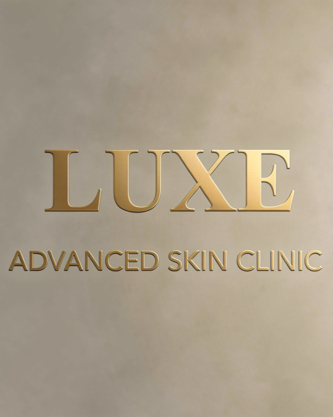 LUXE logo with 'Advanced Skin Clinic' text underneath on a beige wall.