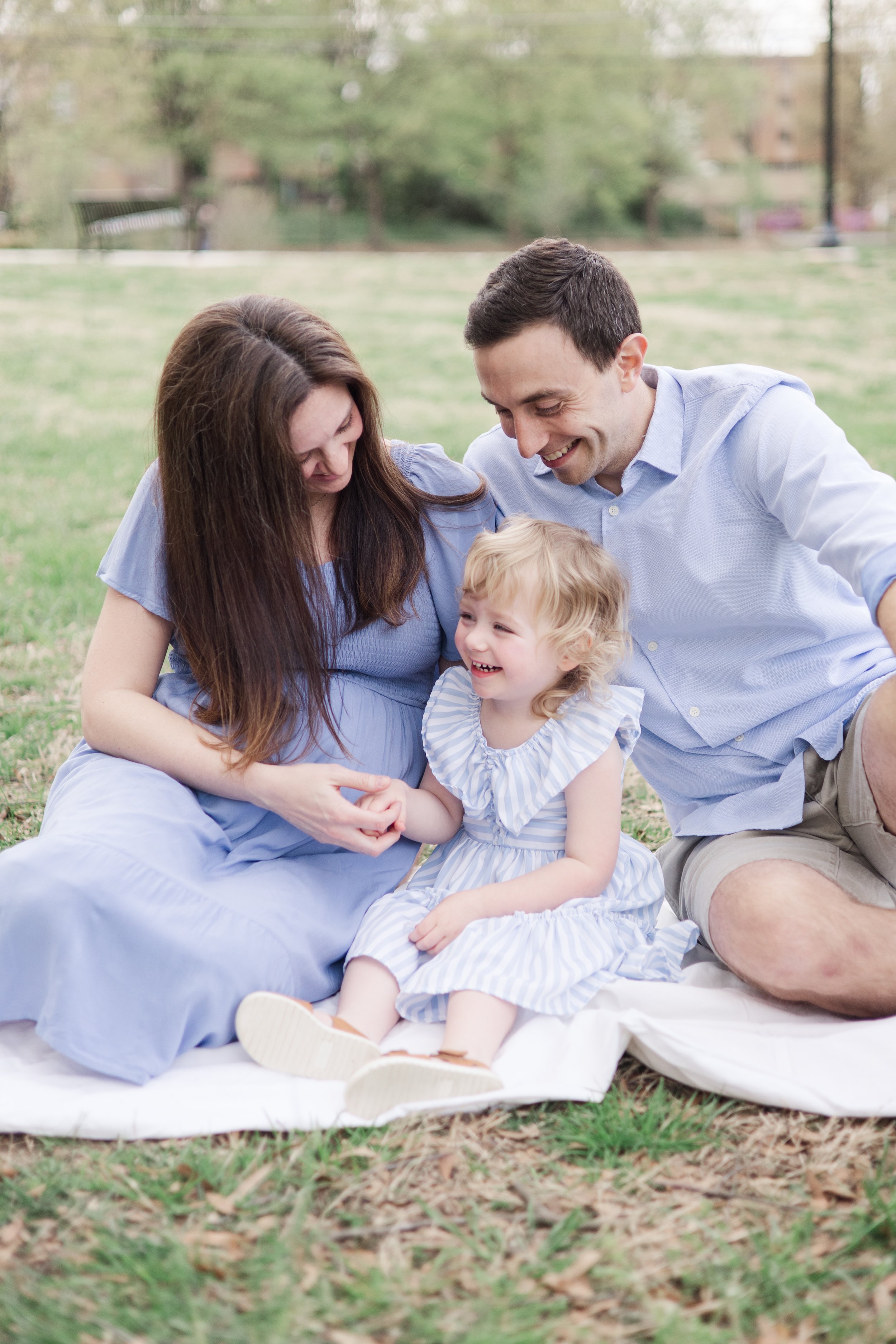Smiling family maternity photoshoot toddler