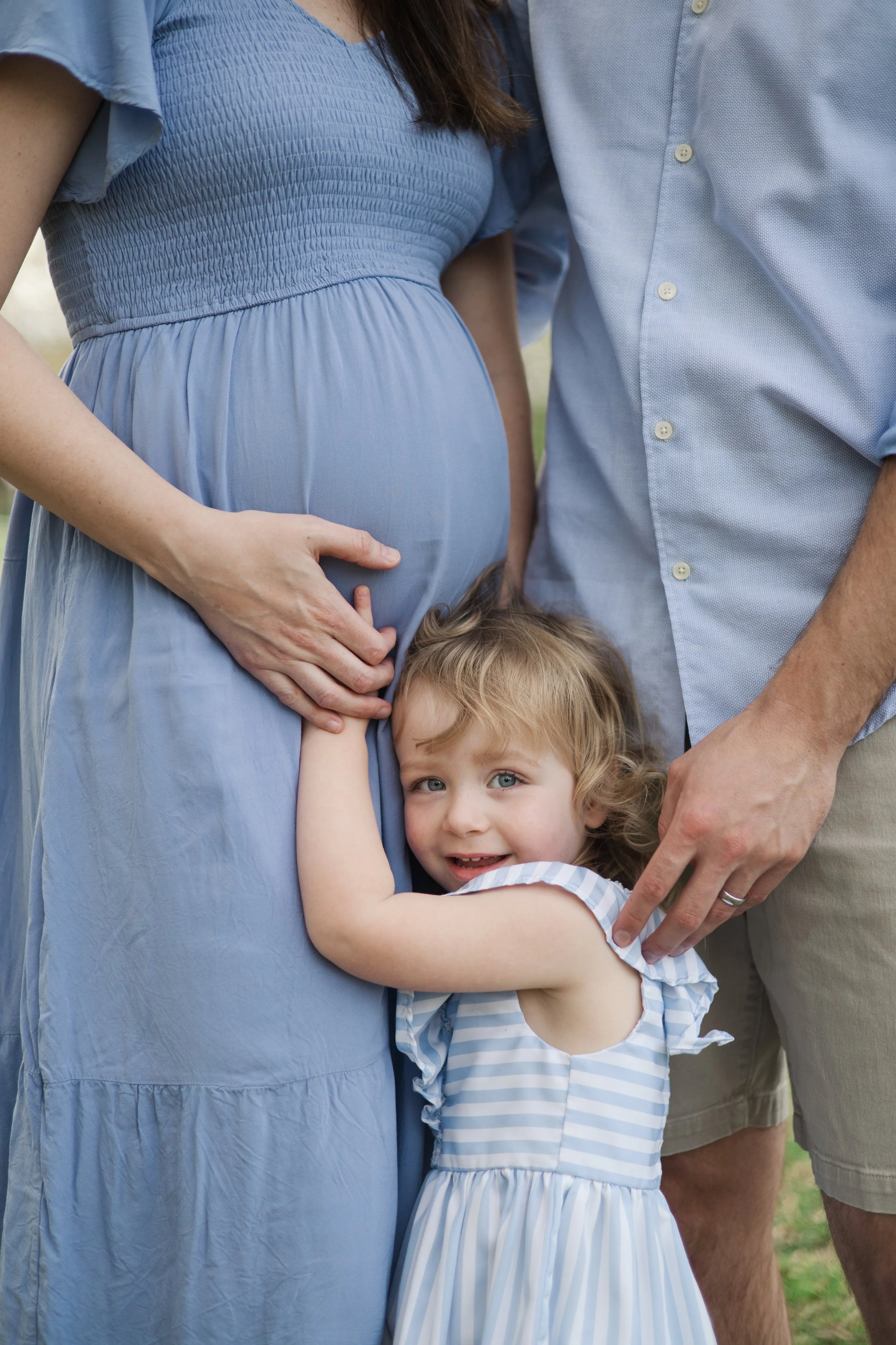 Toddler hugging his mother's baby bump during a family maternity session in Charlotte, North Carolina