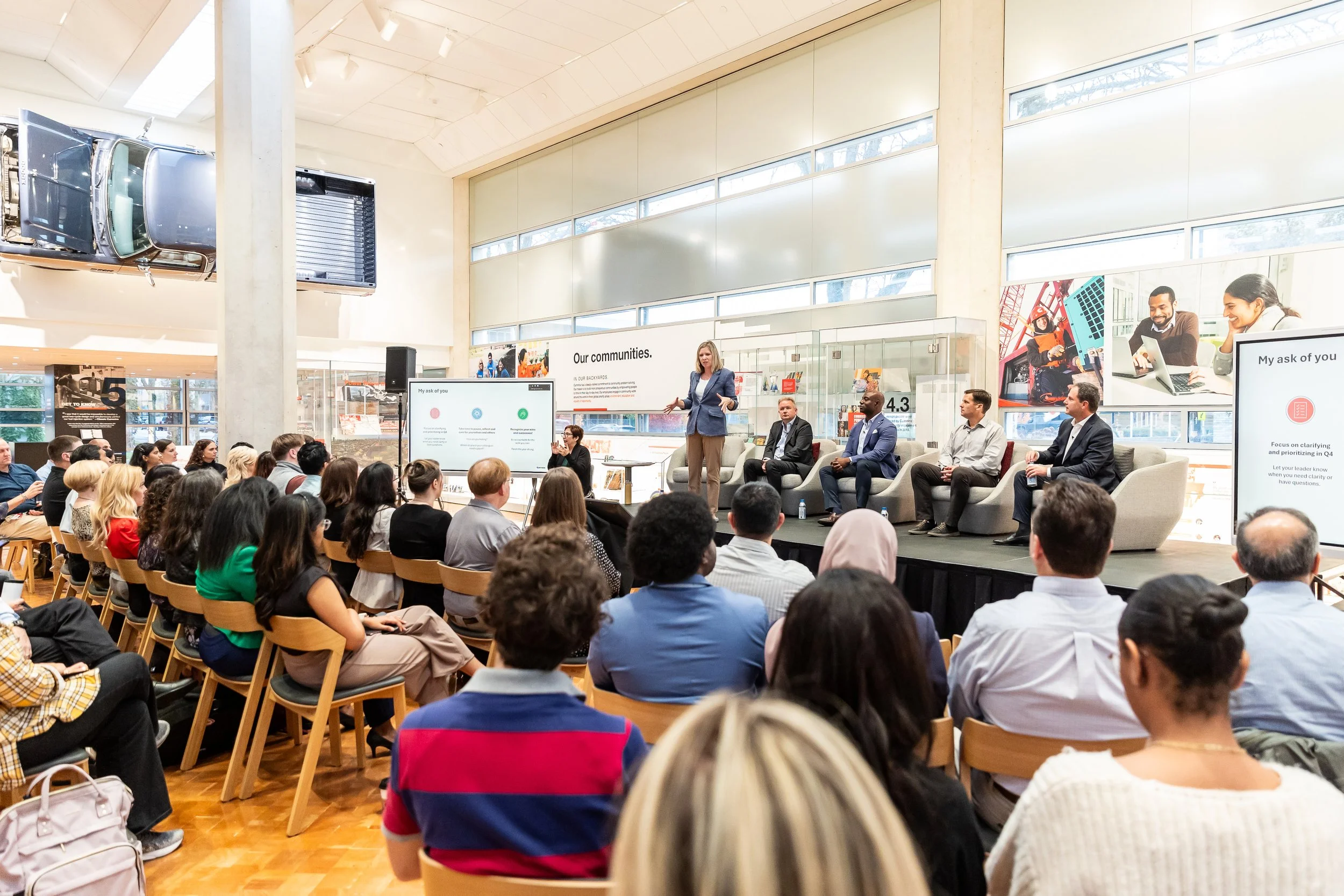 Audience seated in a bright atrium listening to a speaker at a corporate town hall, Indianapolis event photography