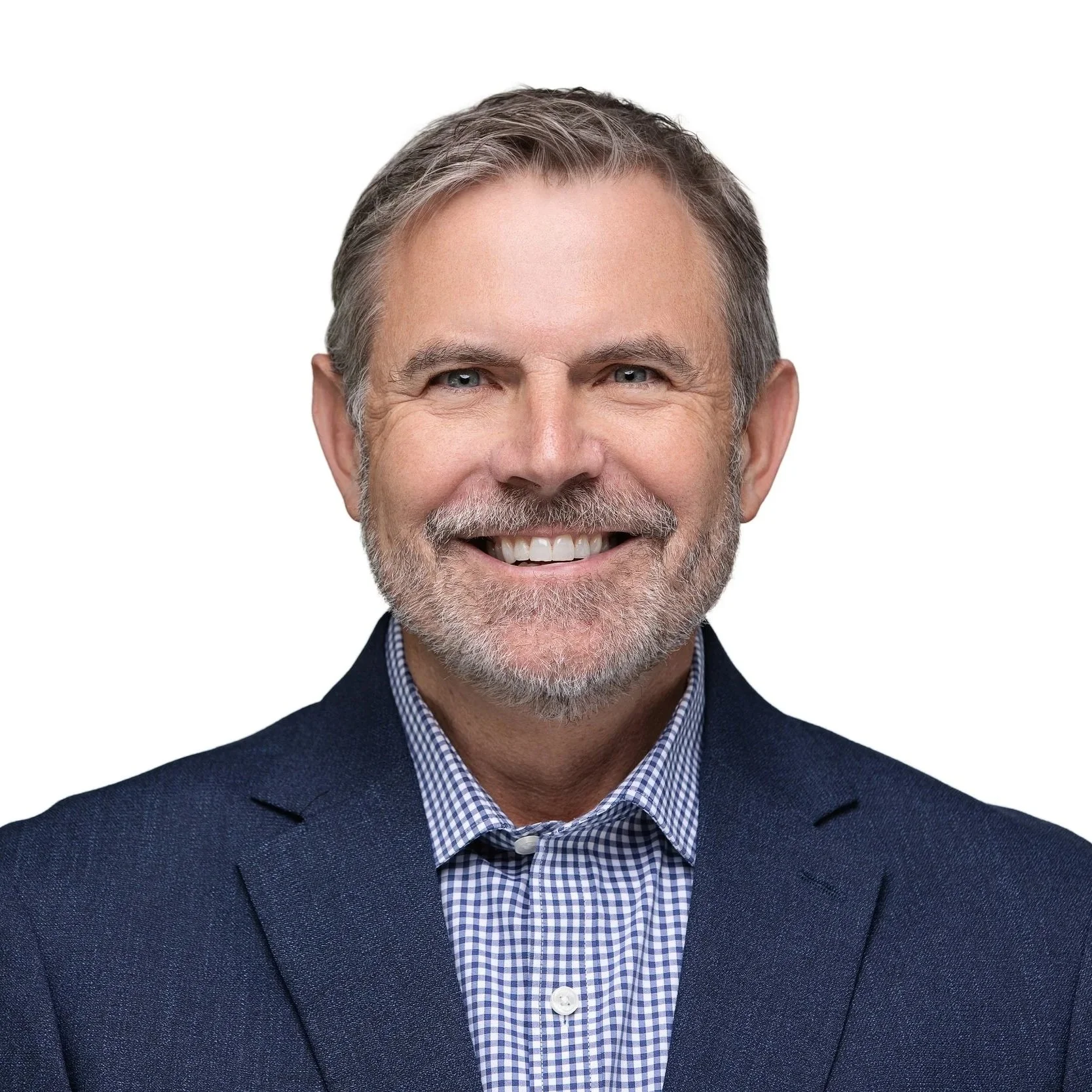Smiling man with gray hair in a navy blazer, executive headshot by Square Mouth Studios