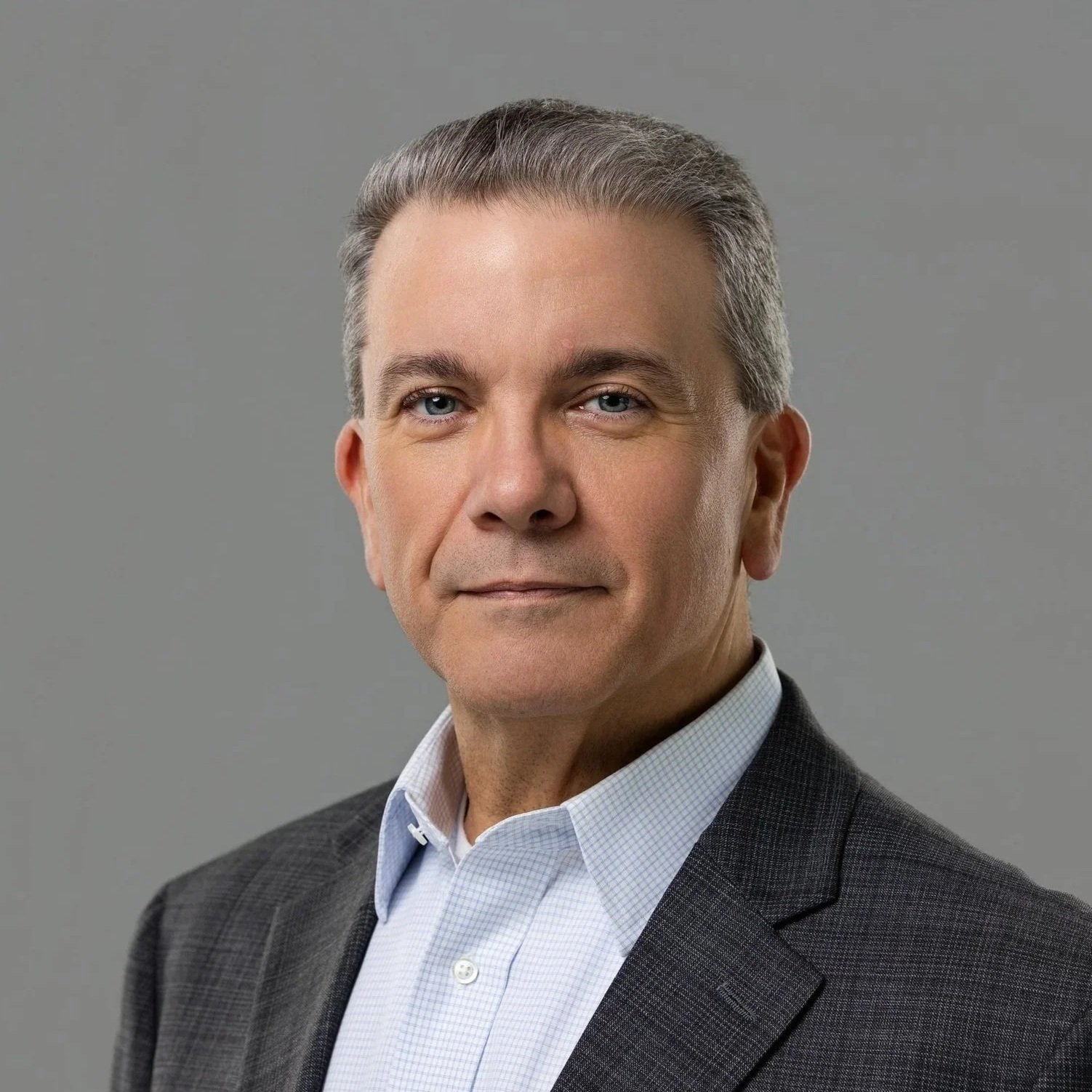 Gray-haired businessman in a charcoal suit, executive headshot in Fishers, Indiana