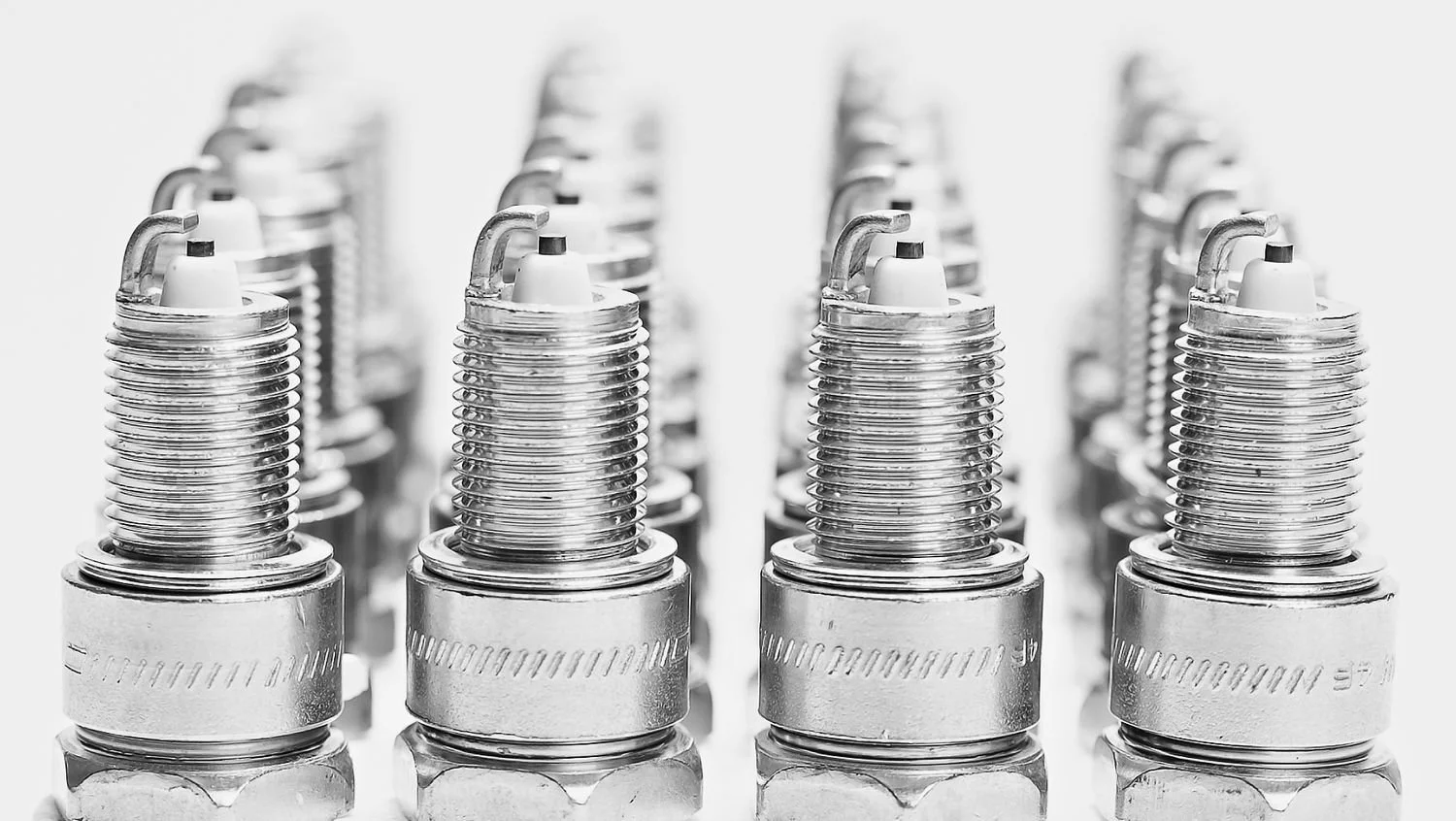 Rows of spark plugs on a white background, industrial product photography in Fishers, Indiana