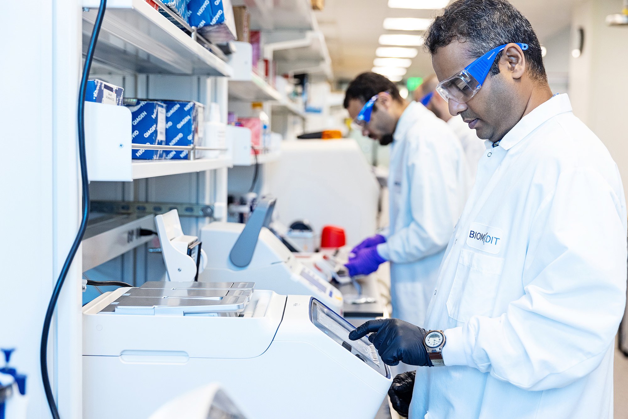 BiomEdit scientists in safety glasses and lab coats working in their lab, Indiana brand photography